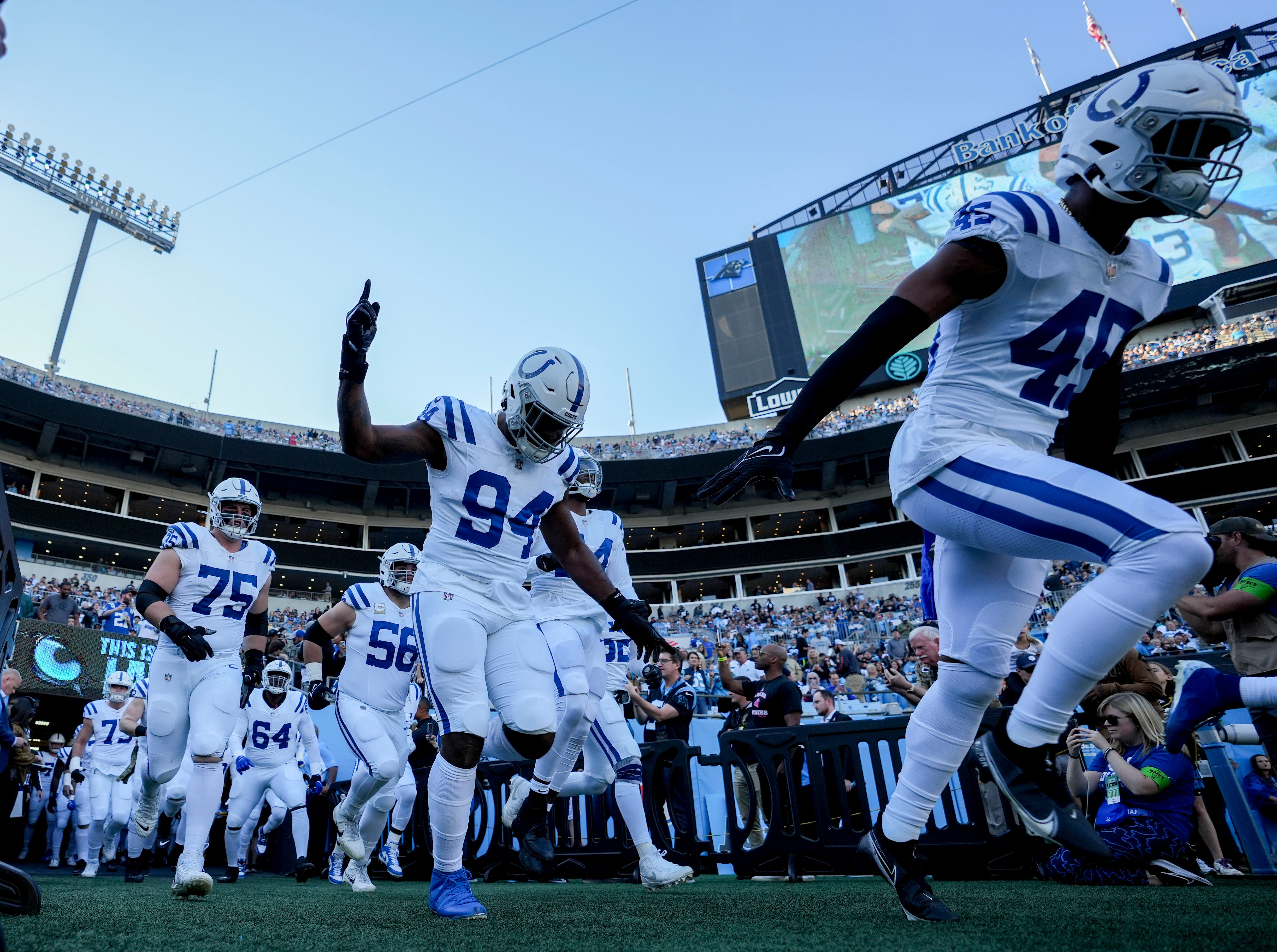 Indianapolis Colts defensive end Tyquan Lewis (94) and Indianapolis Colts linebacker E.J. Speed (45) take the field with their teammates Sunday, Nov. 5, 2023, before a game against the Carolina Panthers at Bank of America Stadium in Charlotte.