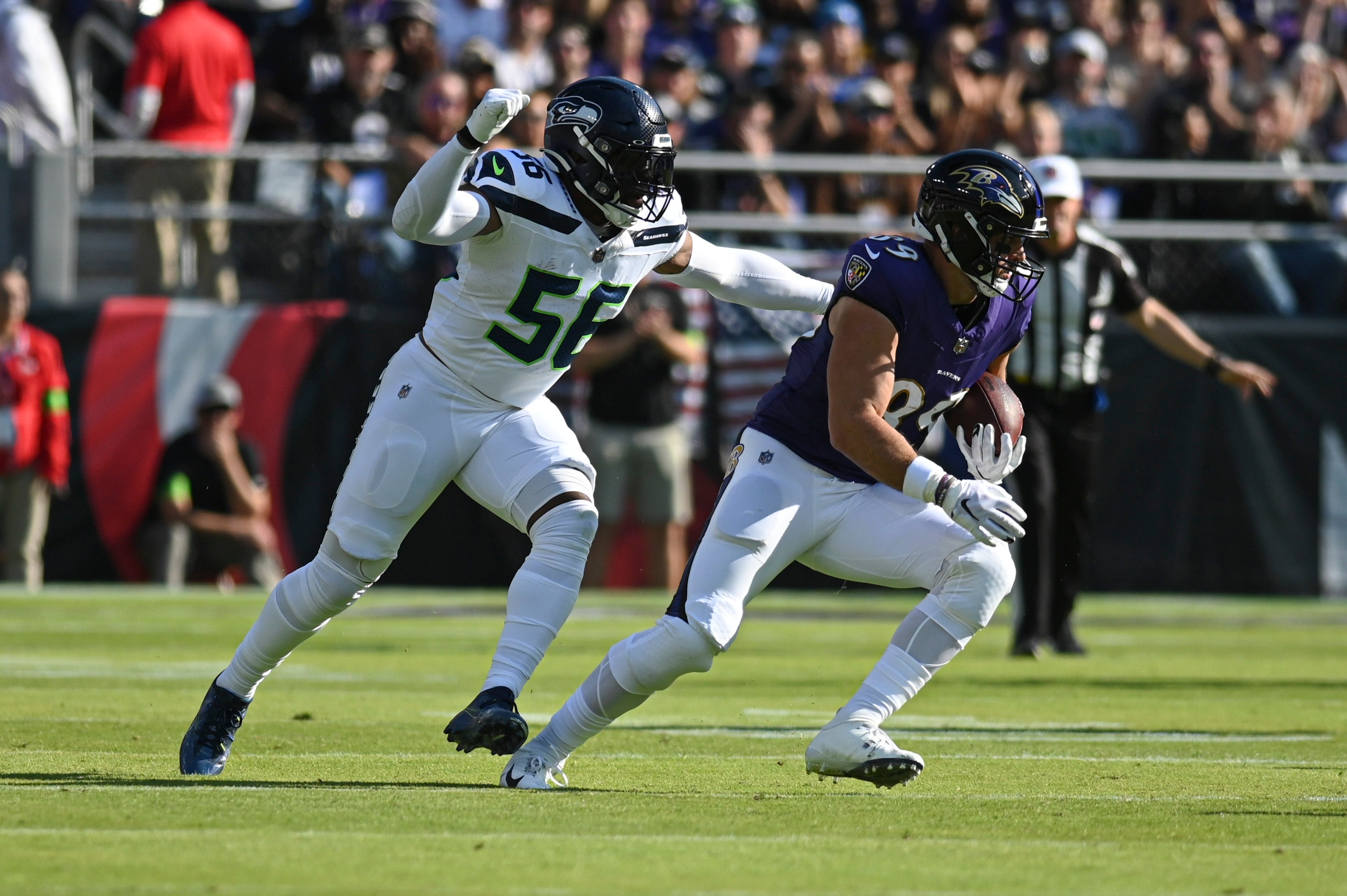 Nov 5, 2023; Baltimore, Maryland, USA; Baltimore Ravens tight end Mark Andrews (89)] runs after the catch as Seattle Seahawks linebacker Jordyn Brooks (56) defends during the first half at M&T Bank Stadium.