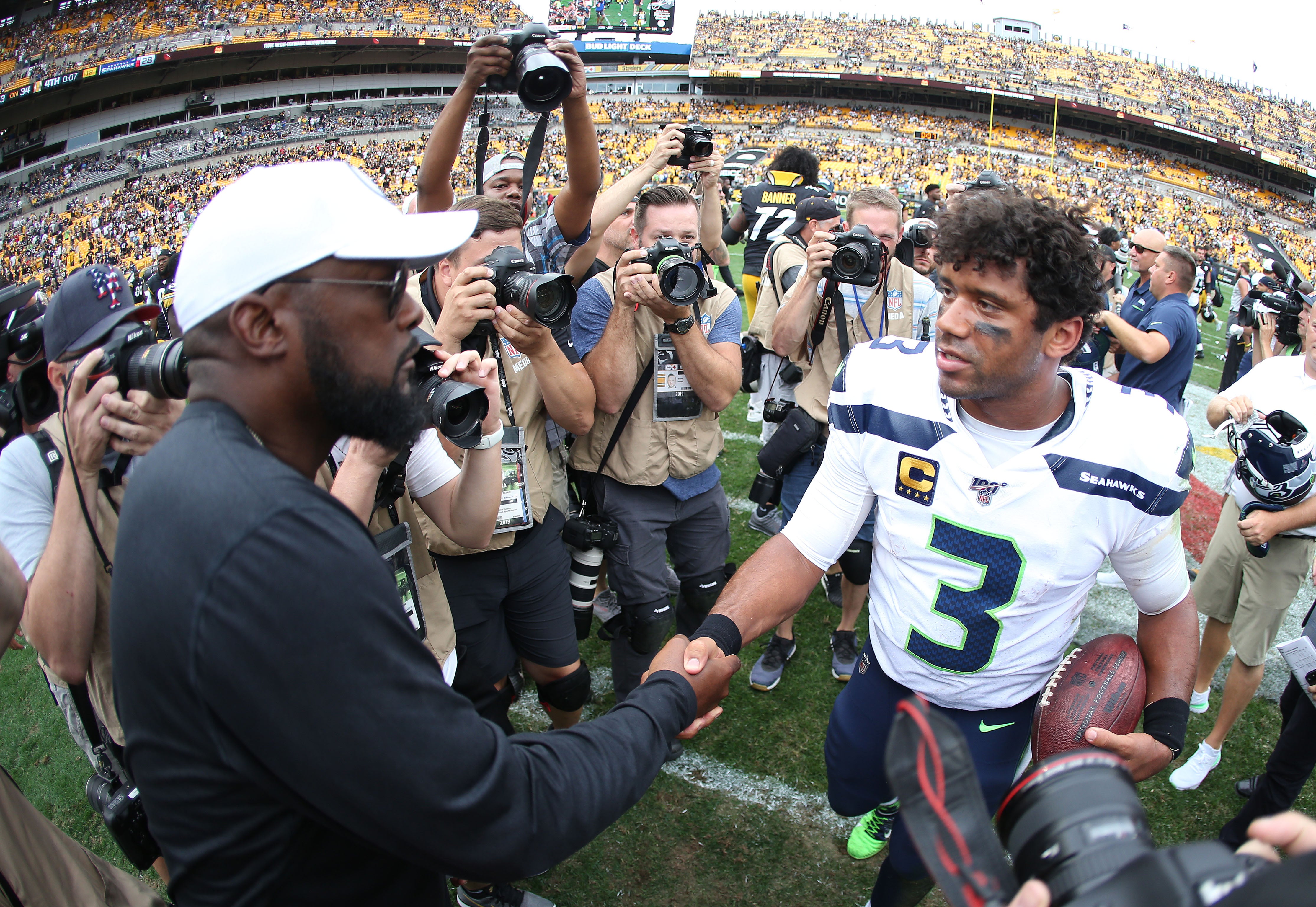 Sep 15, 2019; Pittsburgh, PA, USA; Pittsburgh Steelers head coach Mike Tomlin (left) and Seattle Seahawks quarterback Russell Wilson (3) shake hands after a game at Heinz Field. Mandatory Credit: Charles LeClaire-USA TODAY Sports  