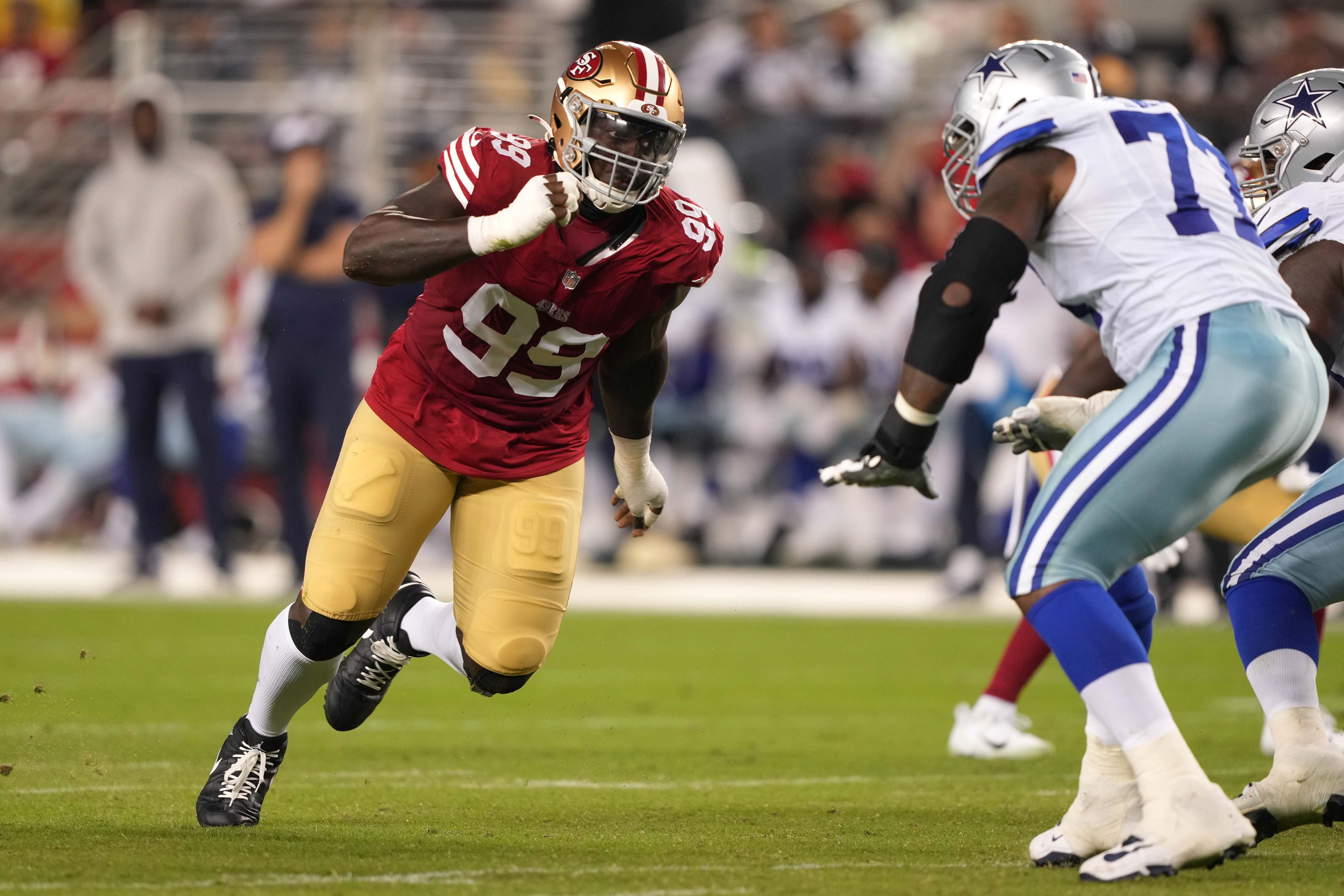 Oct 8, 2023; Santa Clara, California, USA; San Francisco 49ers defensive tackle Javon Kinlaw (99) rushes against Dallas Cowboys offensive tackle Tyron Smith (left) during the fourth quarter at Levi's Stadium. Mandatory Credit: Darren Yamashita-USA TODAY Sports
