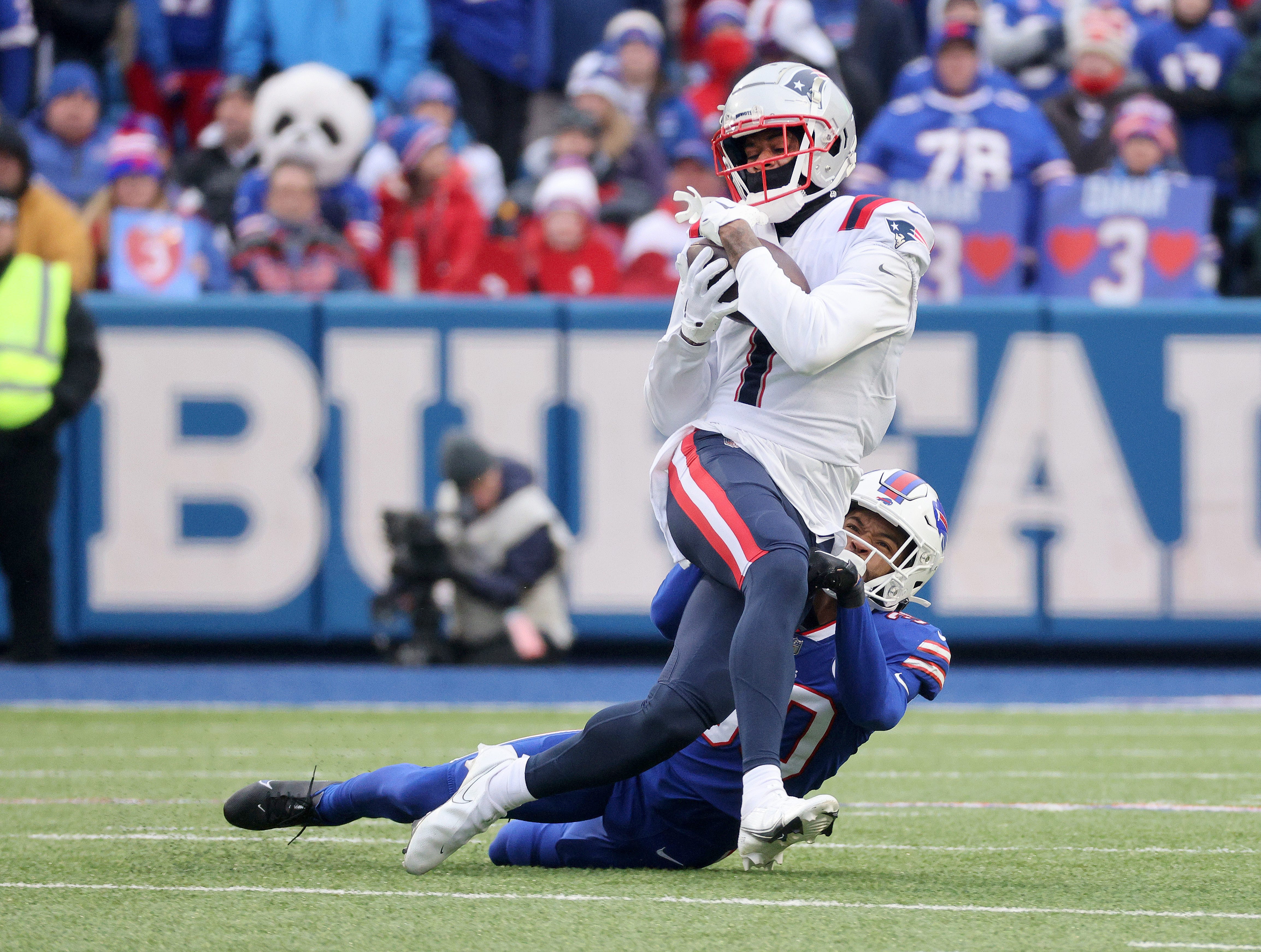 Patriots receiver DeVante Parker is tackle by Bills Dane Jackson after a catch.
