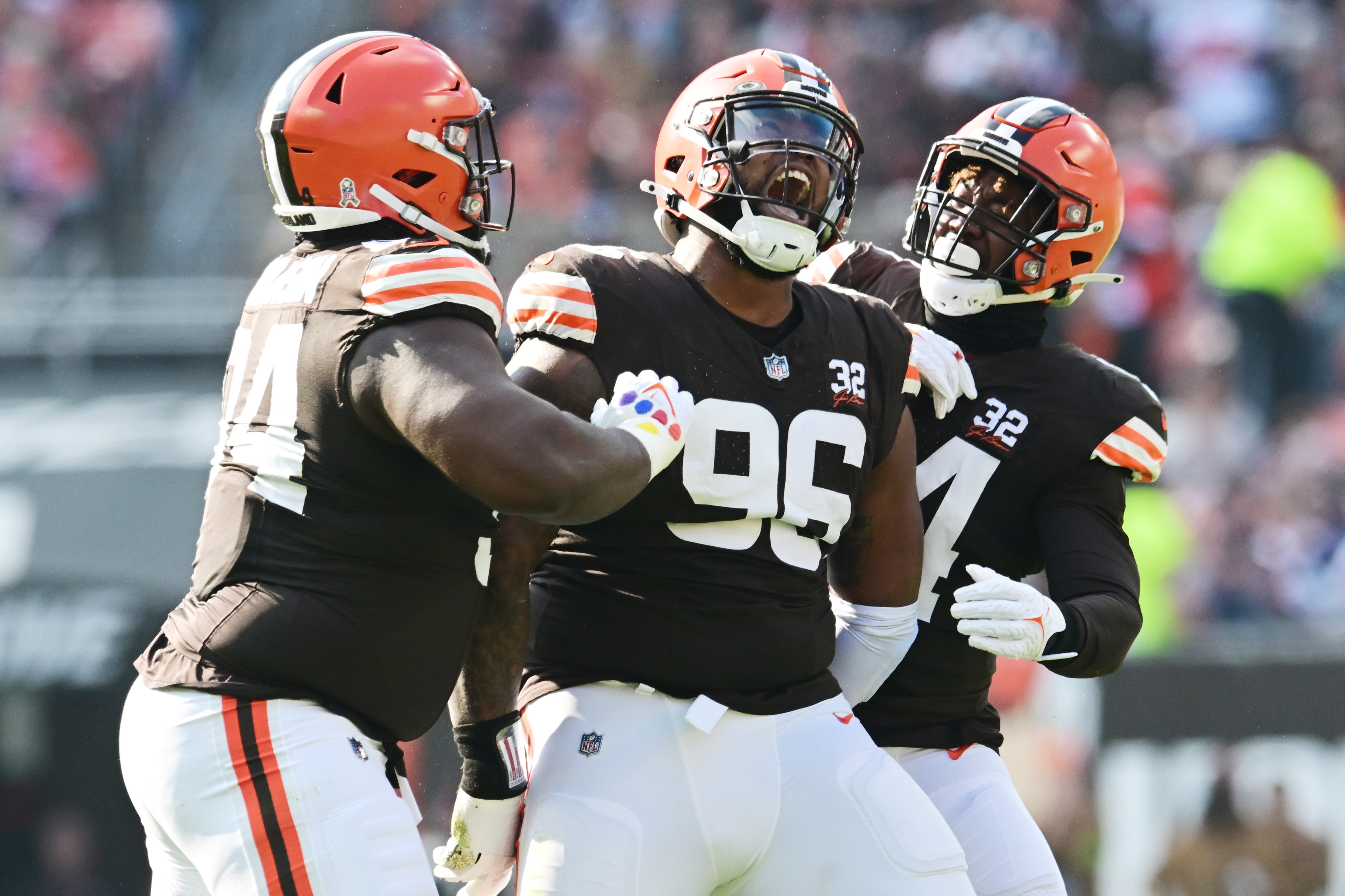 Nov 5, 2023; Cleveland, Ohio, USA; Cleveland Browns defensive tackle Jordan Elliott (96) celebrates with defensive tackle Dalvin Tomlinson (94) defensive end Ogbo Okoronkwo (54) during the first quarter against the Arizona Cardinals at Cleveland Browns Stadium.