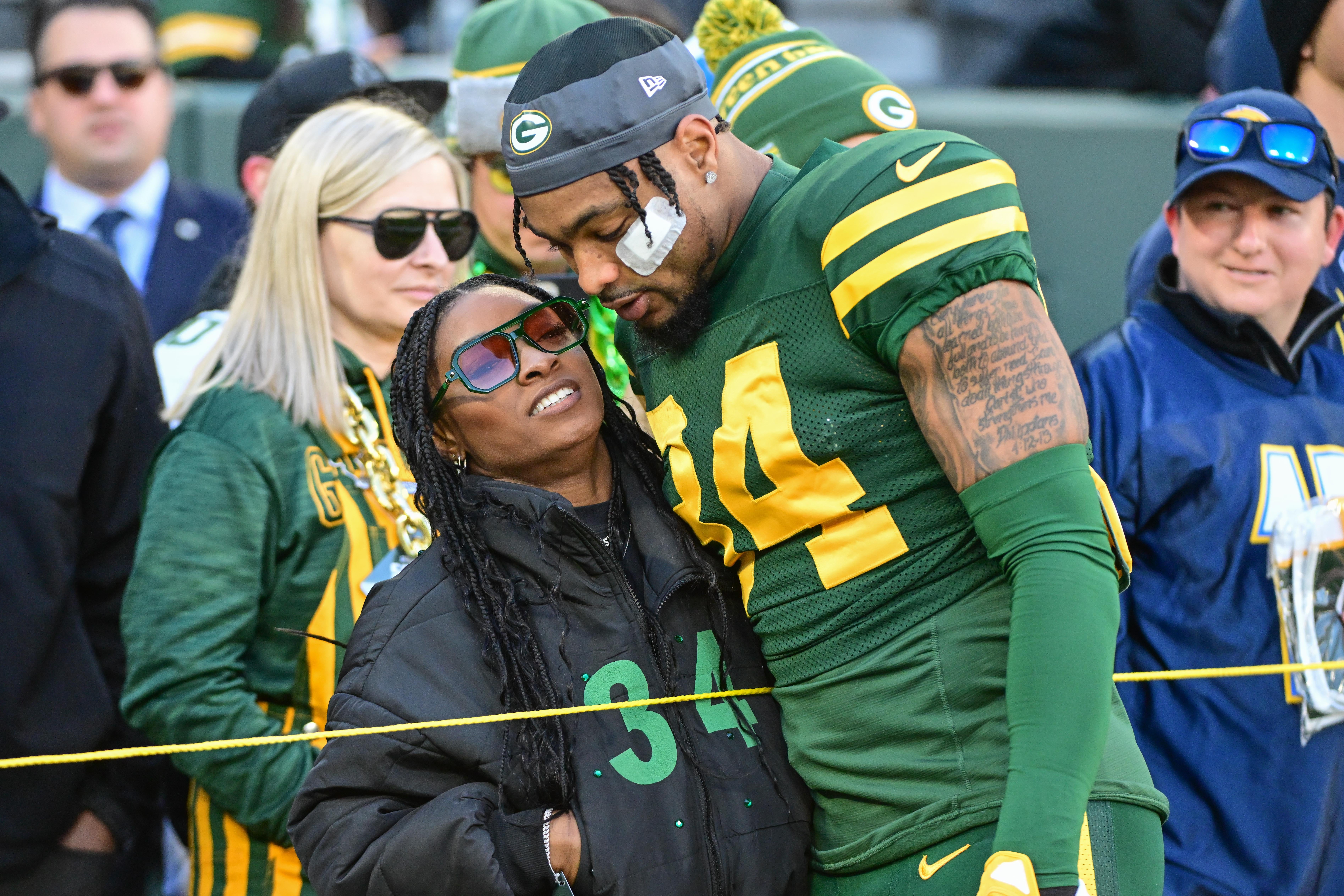 Nov 19, 2023; Green Bay, Wisconsin, USA; Green Bay Packers safety Jonathan Owens (34) hugs his wife, Olympic gymnast Simone Biles, before game against the Los Angeles Chargers at Lambeau Field.