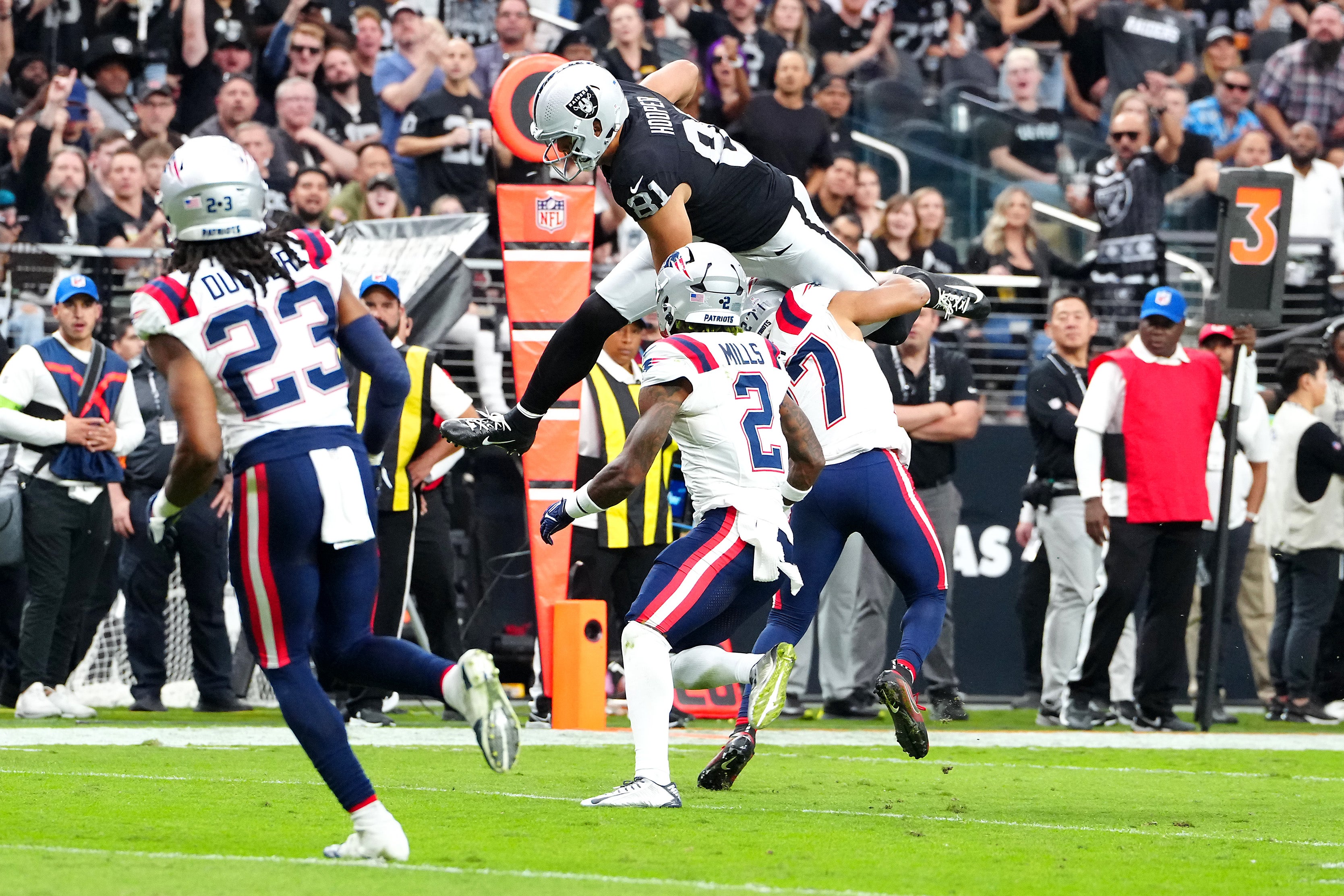Oct 15, 2023; Paradise, Nevada, USA; Las Vegas Raiders tight end Austin Hooper (81) hurdles over New England Patriots cornerback Myles Bryant (27) during the third quarter at Allegiant Stadium.