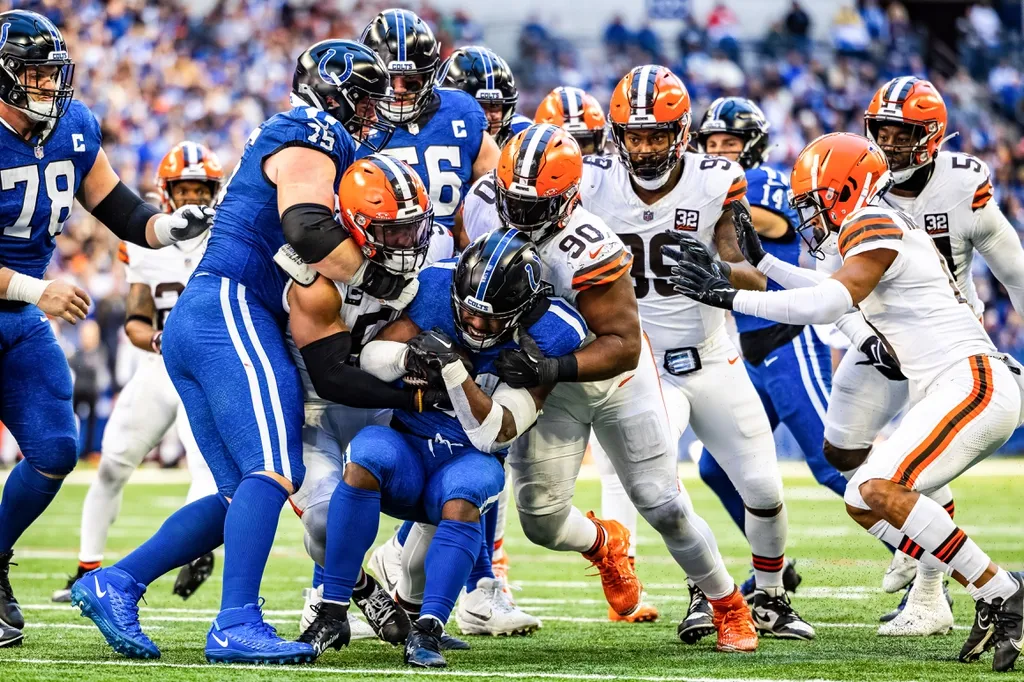 Indianapolis Colts running back Zack Moss (21) runs the ball while Cleveland Browns defensive end Myles Garrett (95) and defensive tackle Maurice Hurst II (90) defend in the second half at Lucas Oil ...