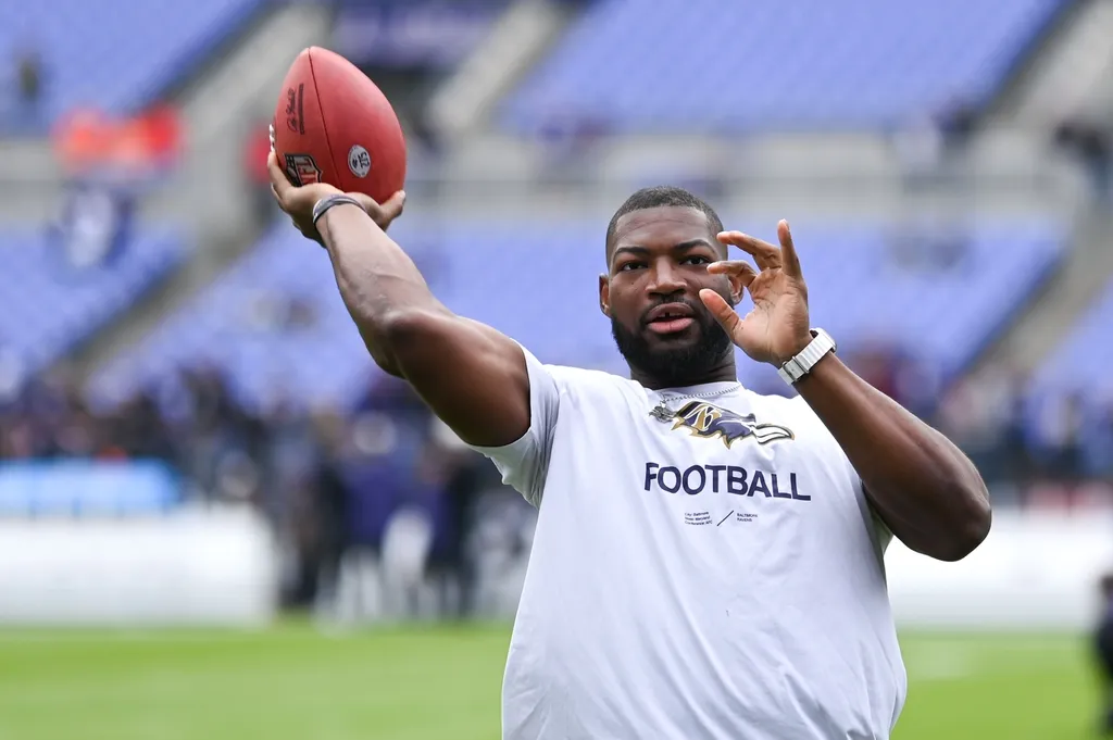 Baltimore Ravens linebacker Tyus Bowser throws a ball for fans before the game against the Cleveland Browns at M&T Bank Stadium.
