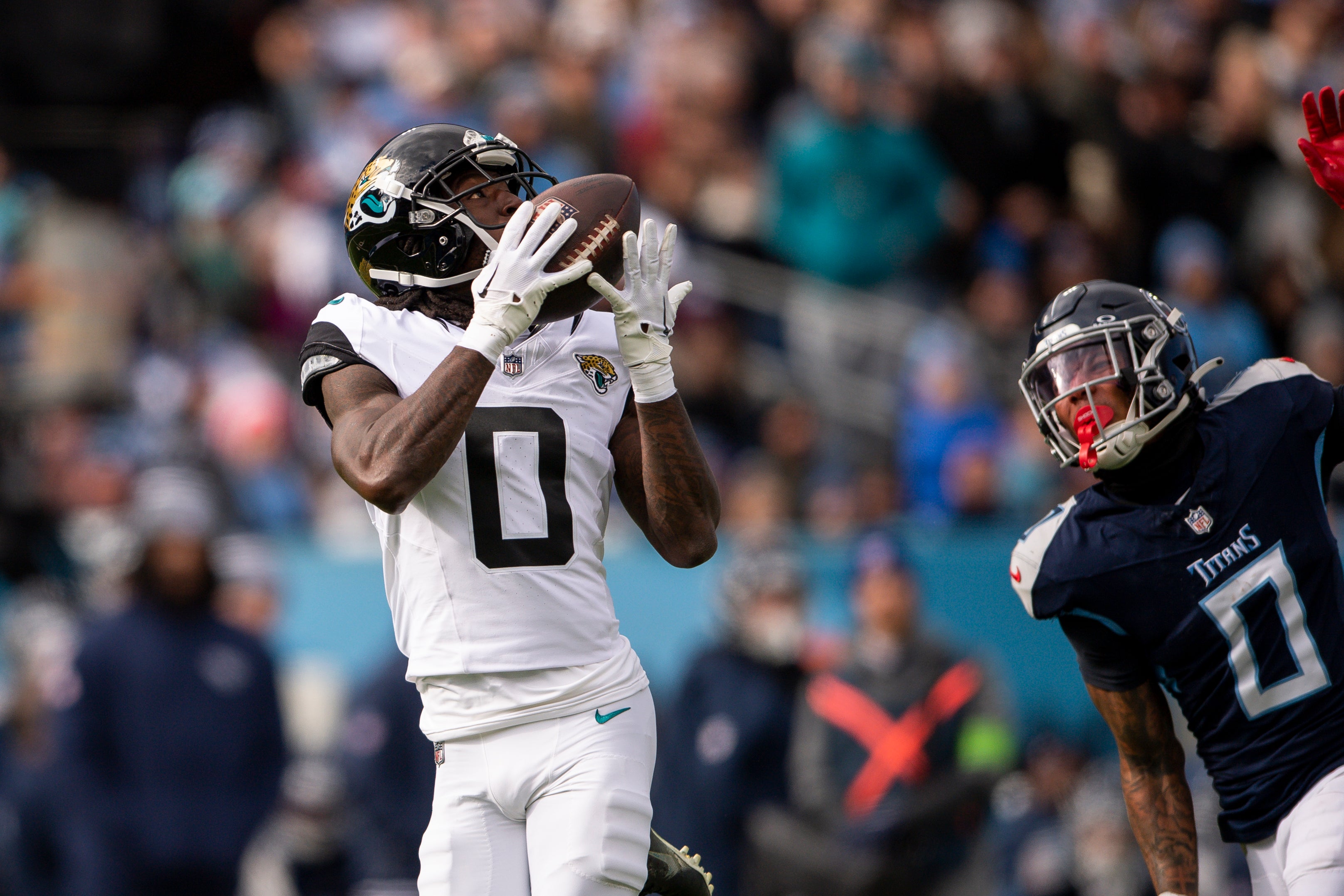 Jan 7, 2024; Nashville, Tennessee, USA; Jacksonville Jaguars wide receiver Calvin Ridley (0) scores a touchdown against the Tennessee Titans during the first half at Nissan Stadium. Mandatory Credit: Steve Roberts-USA TODAY Sports  