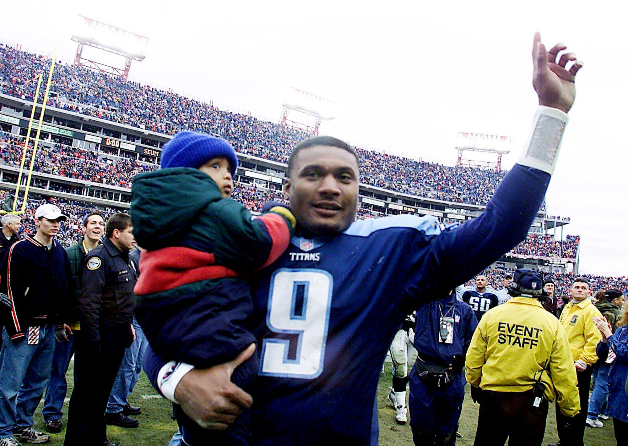 Tennessee Titans quarterback Steve McNair (9), holding his son, celebrates with the fans after the Titans 22-16 victory over the Buffalo Bills in the AFC wildcard playoff game at Adelphia Coliseum Jan. 8, 2000.