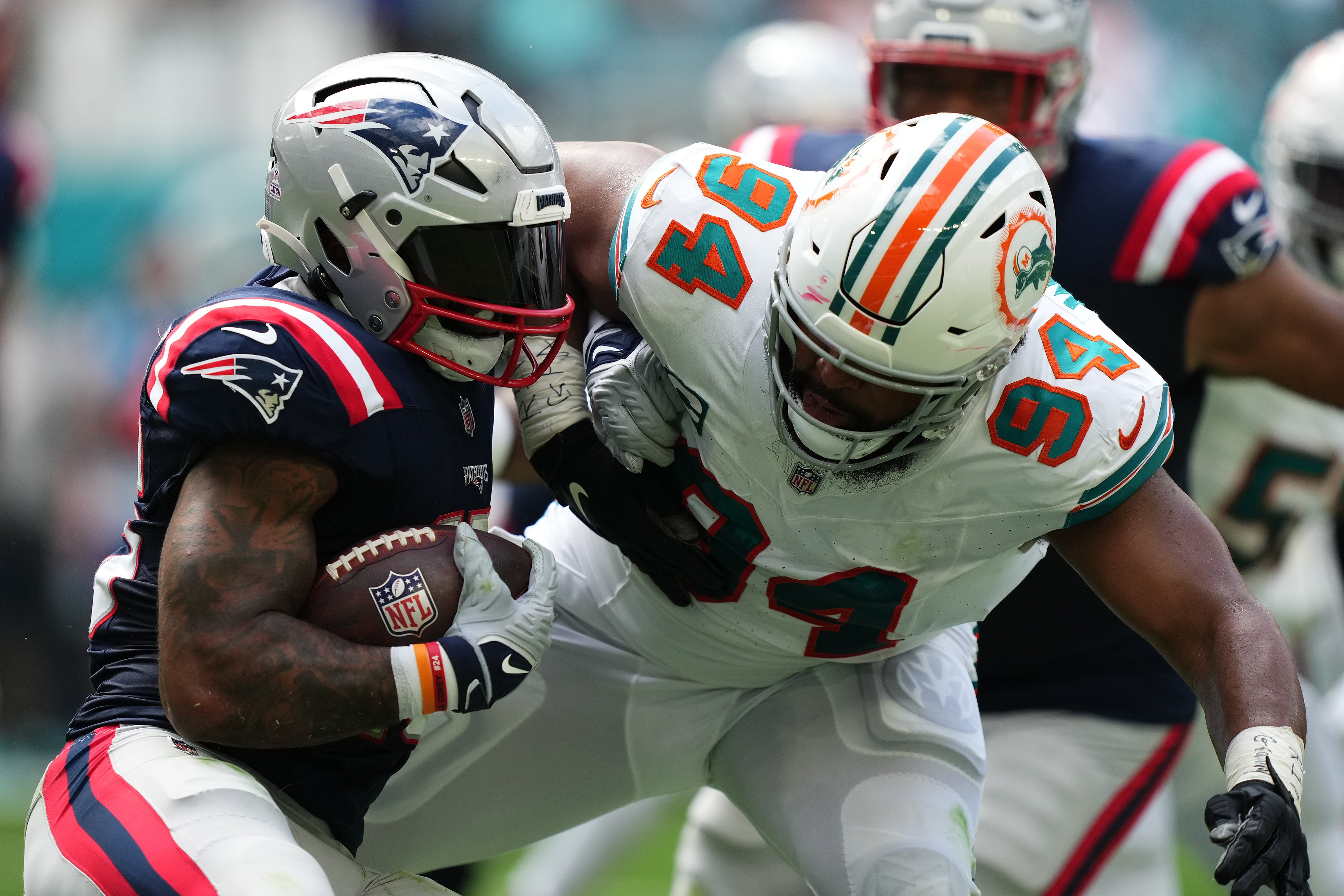 Oct 29, 2023; Miami Gardens, Florida, USA; Miami Dolphins defensive tackle Christian Wilkins (94) tackles New England Patriots running back Ezekiel Elliott (15) during the first half at Hard Rock Stadium.