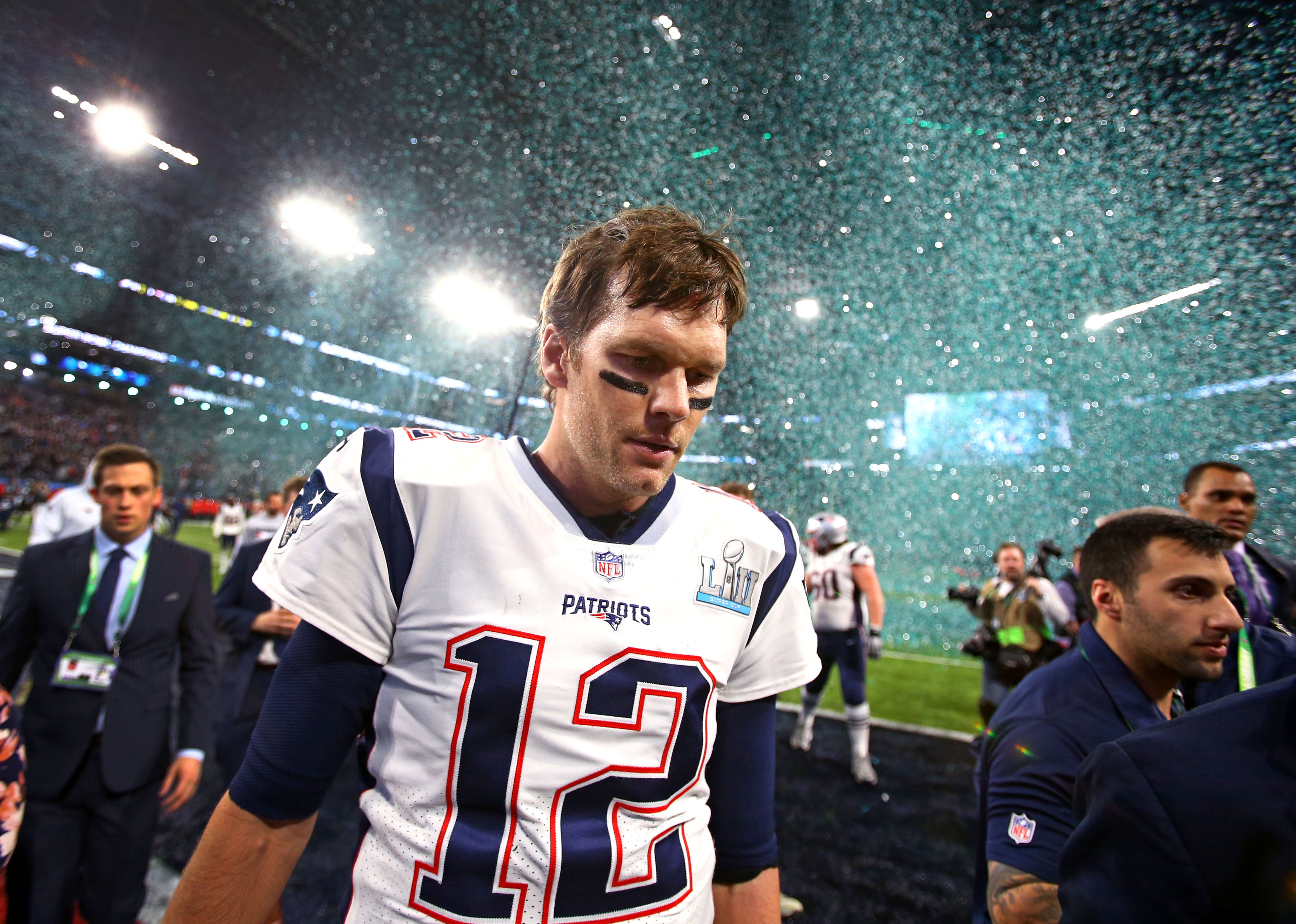 Feb 4, 2018; Minneapolis, MN, USA; Confetti falls as New England Patriots quarterback Tom Brady (12) walks off the field after Super Bowl LII against the Philadelphia Eagles at U.S. Bank Stadium.