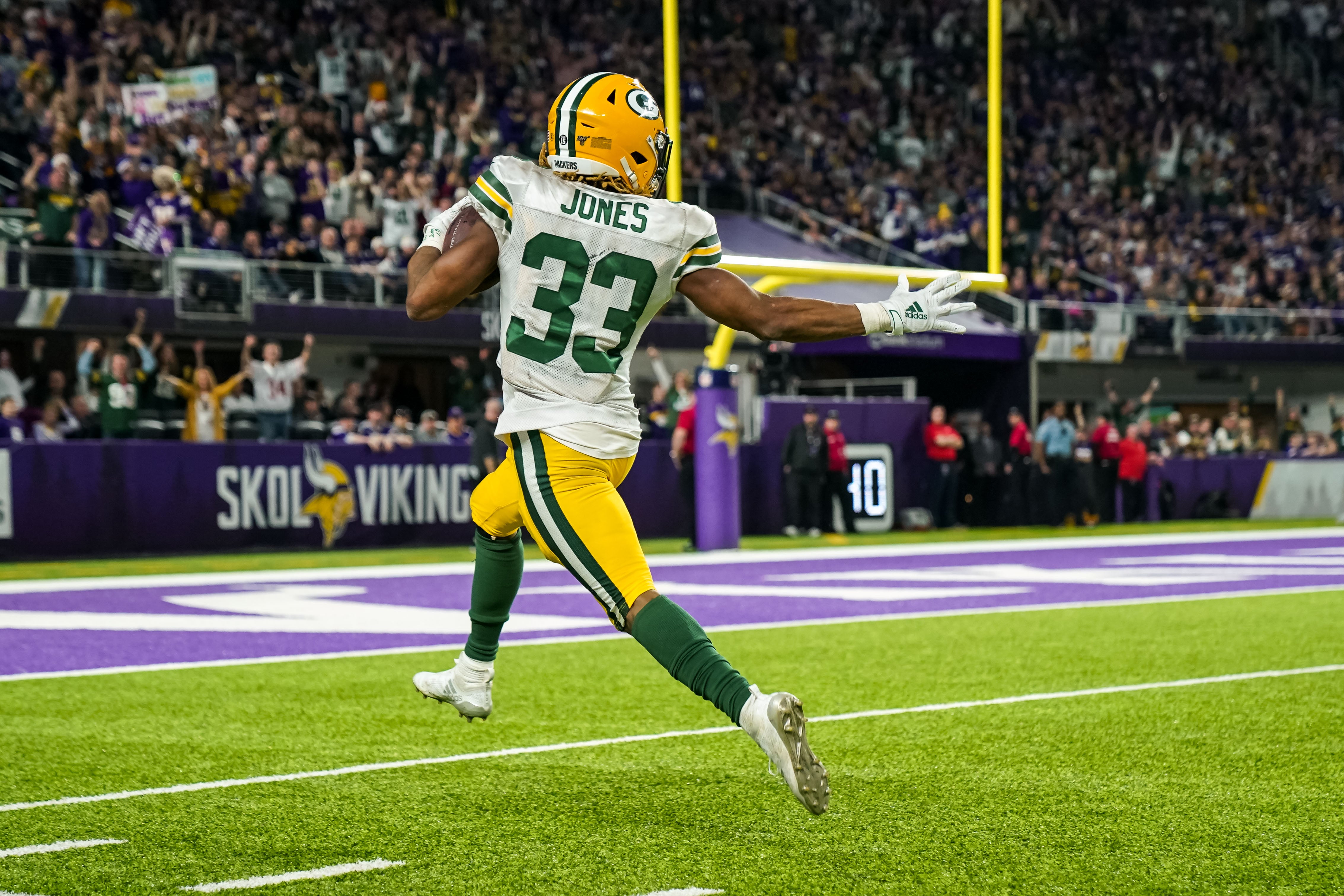 Dec 23, 2019; Minneapolis, Minnesota, USA; Green Bay Packers running back Aaron Jones (33) carries the ball for a touchdown during the third quarter against the Minnesota Vikings at U.S. Bank Stadium.