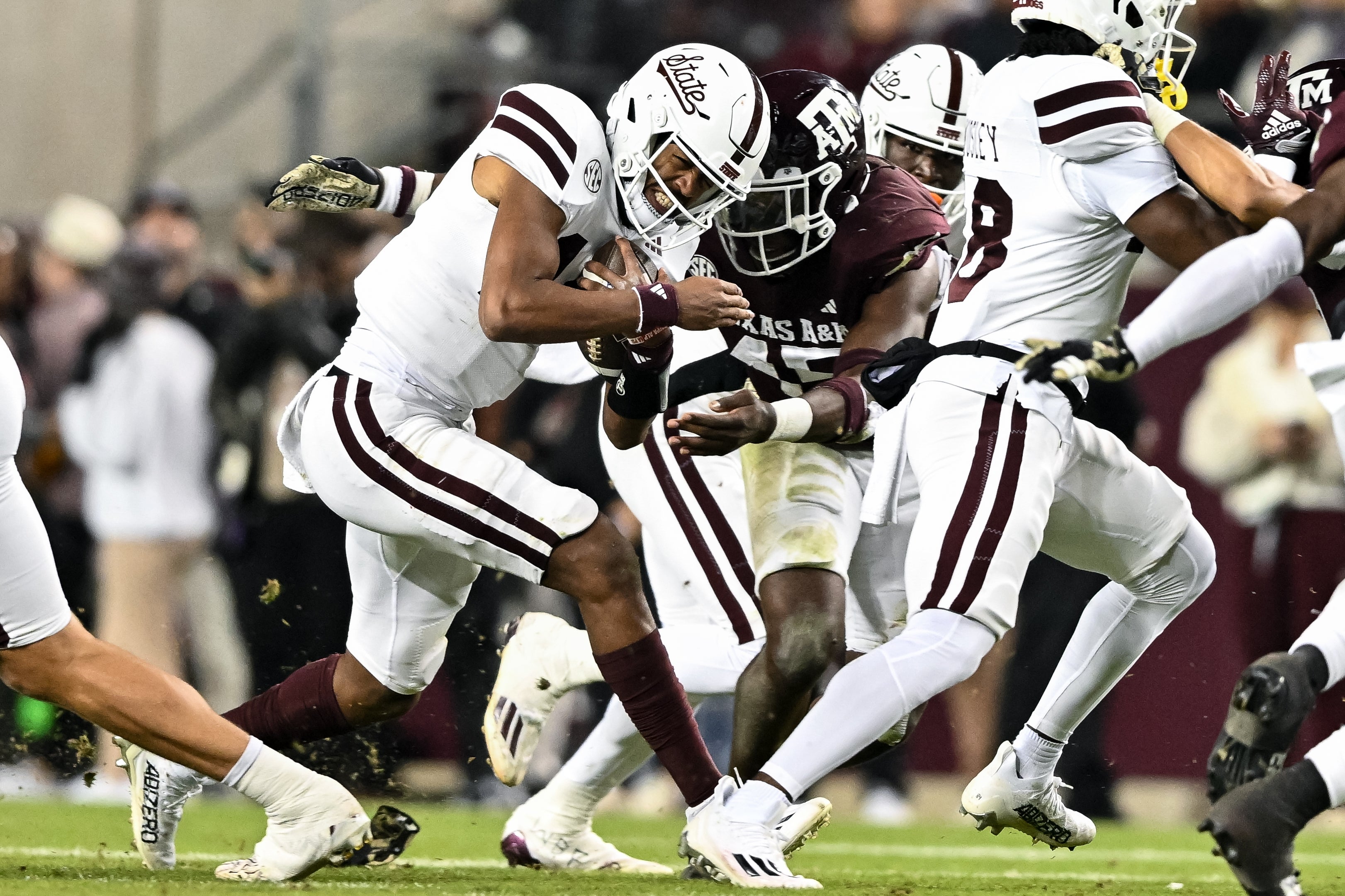 Nov 11, 2023; College Station, Texas, USA; Mississippi State Bulldogs quarterback Mike Wright (14) is tackled by Texas A&M Aggies linebacker Edgerrin Cooper (45) during the second half at Kyle Field. Mandatory Credit: Maria Lysaker-USA TODAY Sports