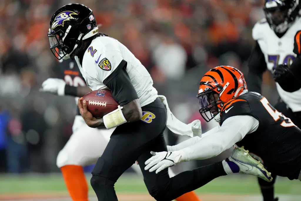 Cincinnati Bengals defensive end Joseph Ossai (58) sacks Baltimore Ravens quarterback Tyler Huntley (2) in the courth quarter during an NFL wild-card playoff football game between the Baltimore Ravens...