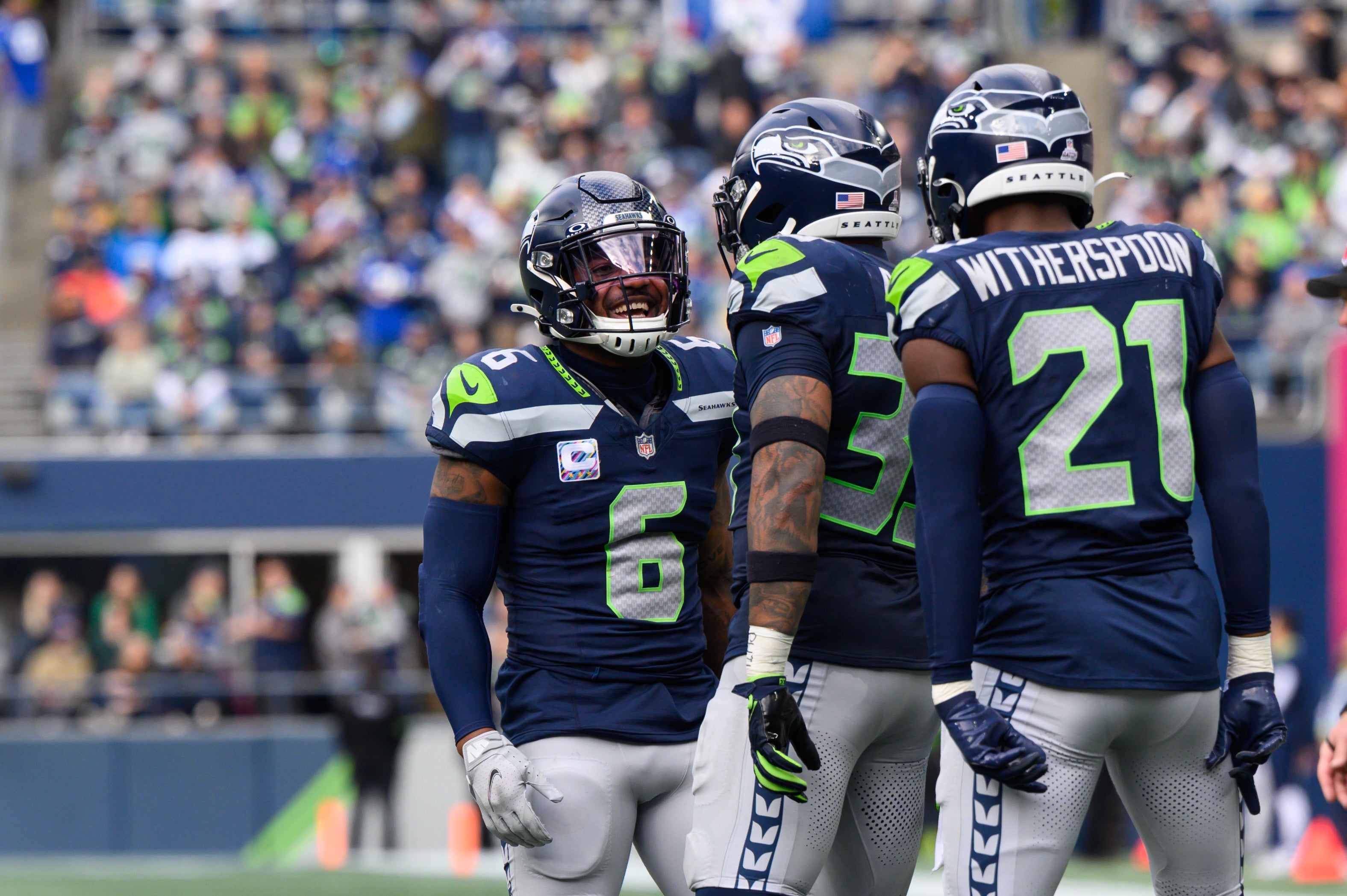 Oct 22, 2023; Seattle, Washington, USA; Seattle Seahawks safety Quandre Diggs (6) and safety Jamal Adams (33) and cornerback Devon Witherspoon (21) celebrate after the defense made a play against the Arizona Cardinals during the second half at Lumen Field.