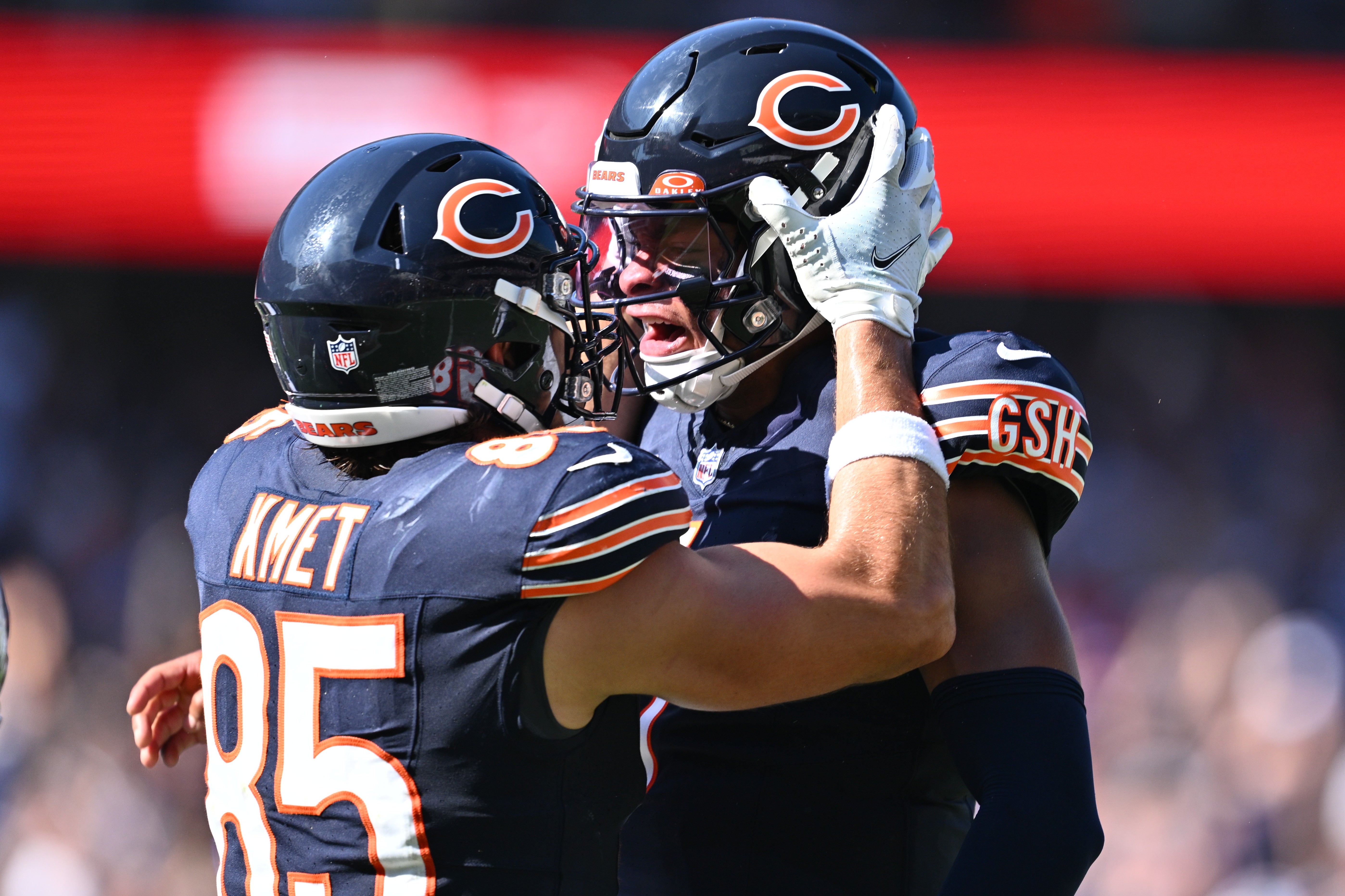 Oct 1, 2023; Chicago, Illinois, USA; Chicago Bears quarterback Justin Fields (1), right, celebrates with tight end Cole Kmet (85) after throwing his fourth touchdown pass of the day against the Denver Broncos in the third quarter at Soldier Field.