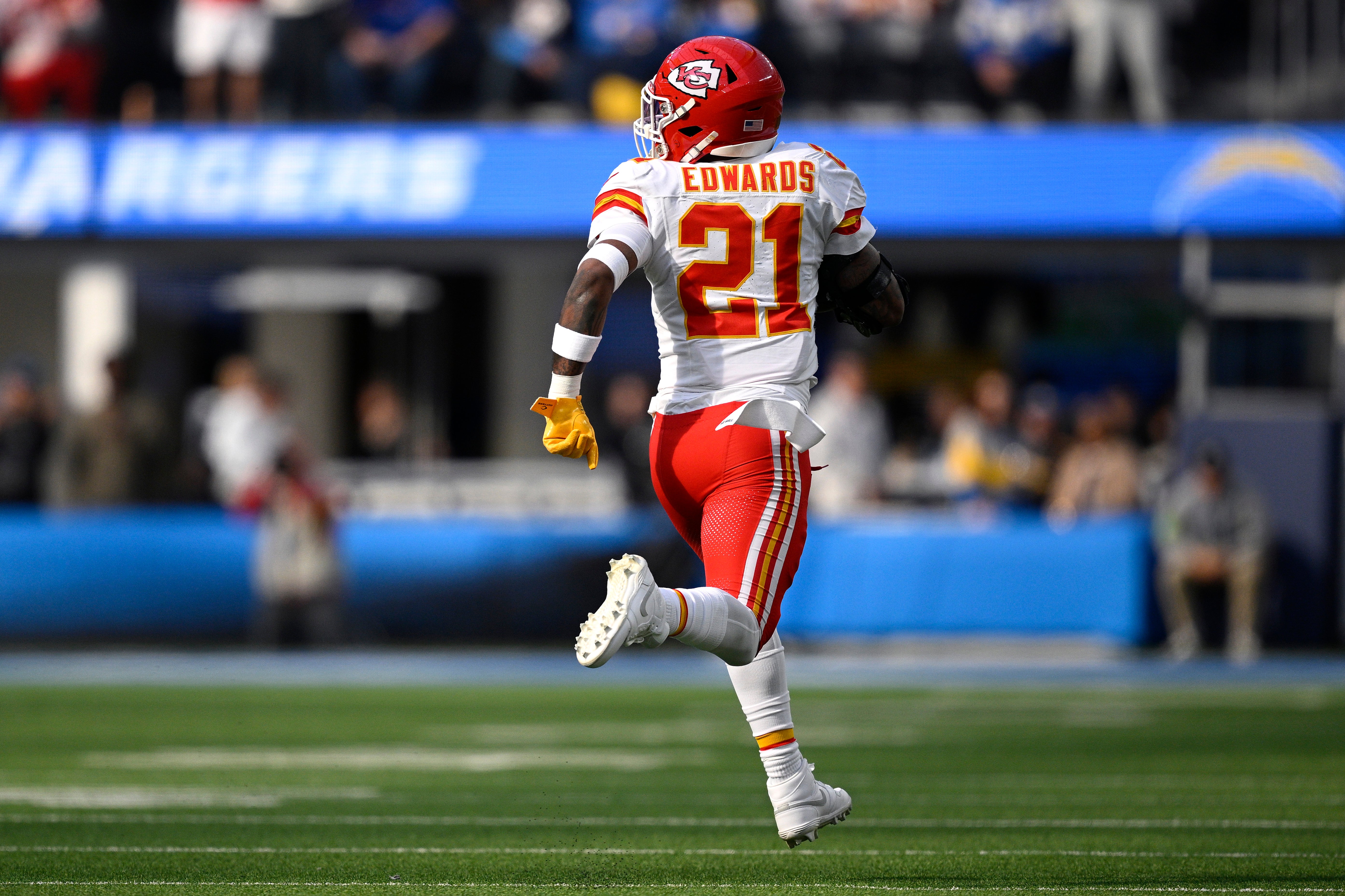 Jan 7, 2024; Inglewood, California, USA; Kansas City Chiefs safety Mike Edwards (21) returns a fumble for a touchdown during the first half against the Los Angeles Chargers at SoFi Stadium.