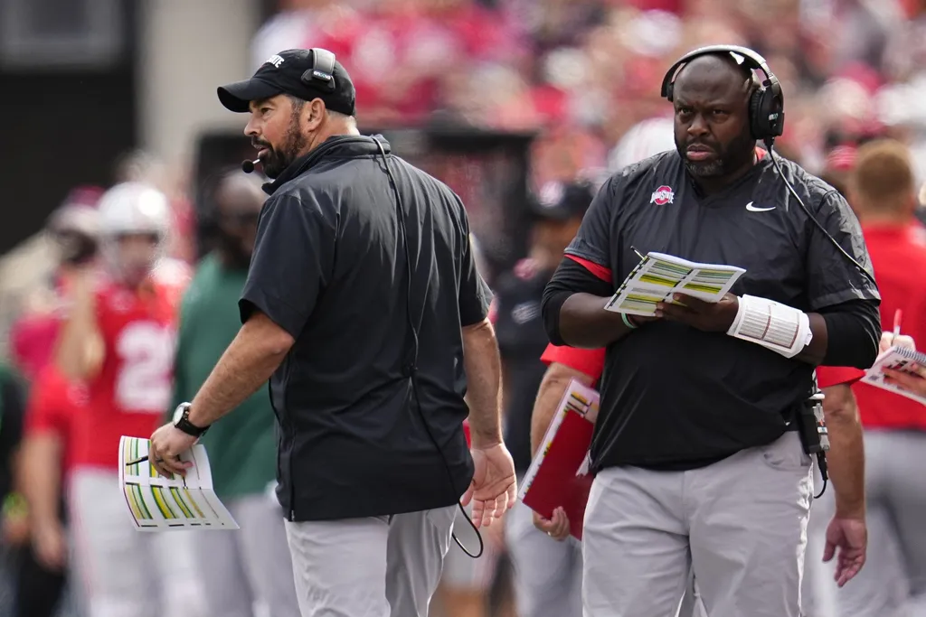Ohio State Buckeyes head coach Ryan Day and running backs coach Tony Alford watch from the sideline during the NCAA football game against the Western Kentucky Hilltoppers at Ohio Stadium.