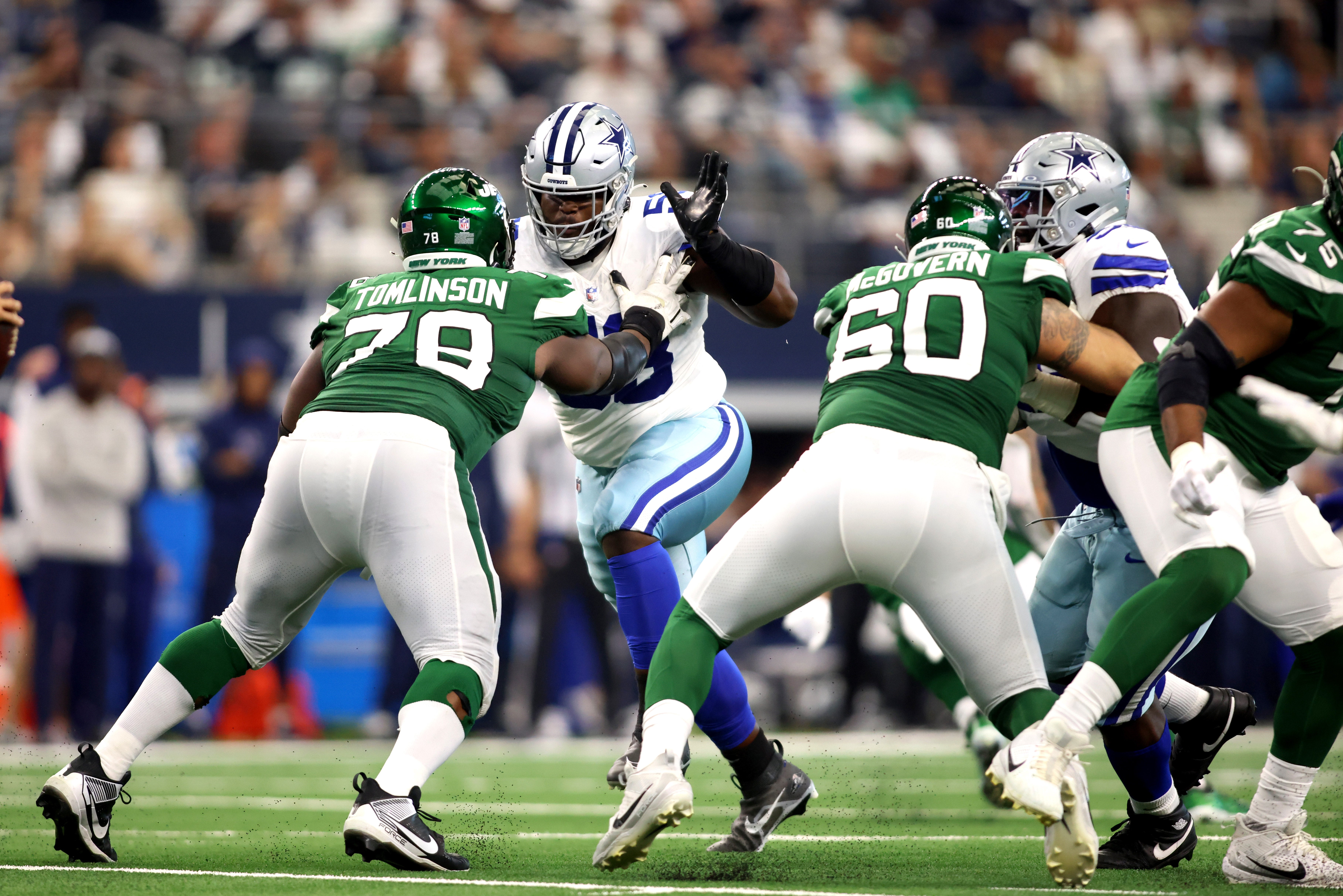 Dallas Cowboys defensive tackle Mazi Smith (58) rushes the passer while blocked by New York Jets guard Laken Tomlinson (78) in the third quarter at AT&T Stadium.