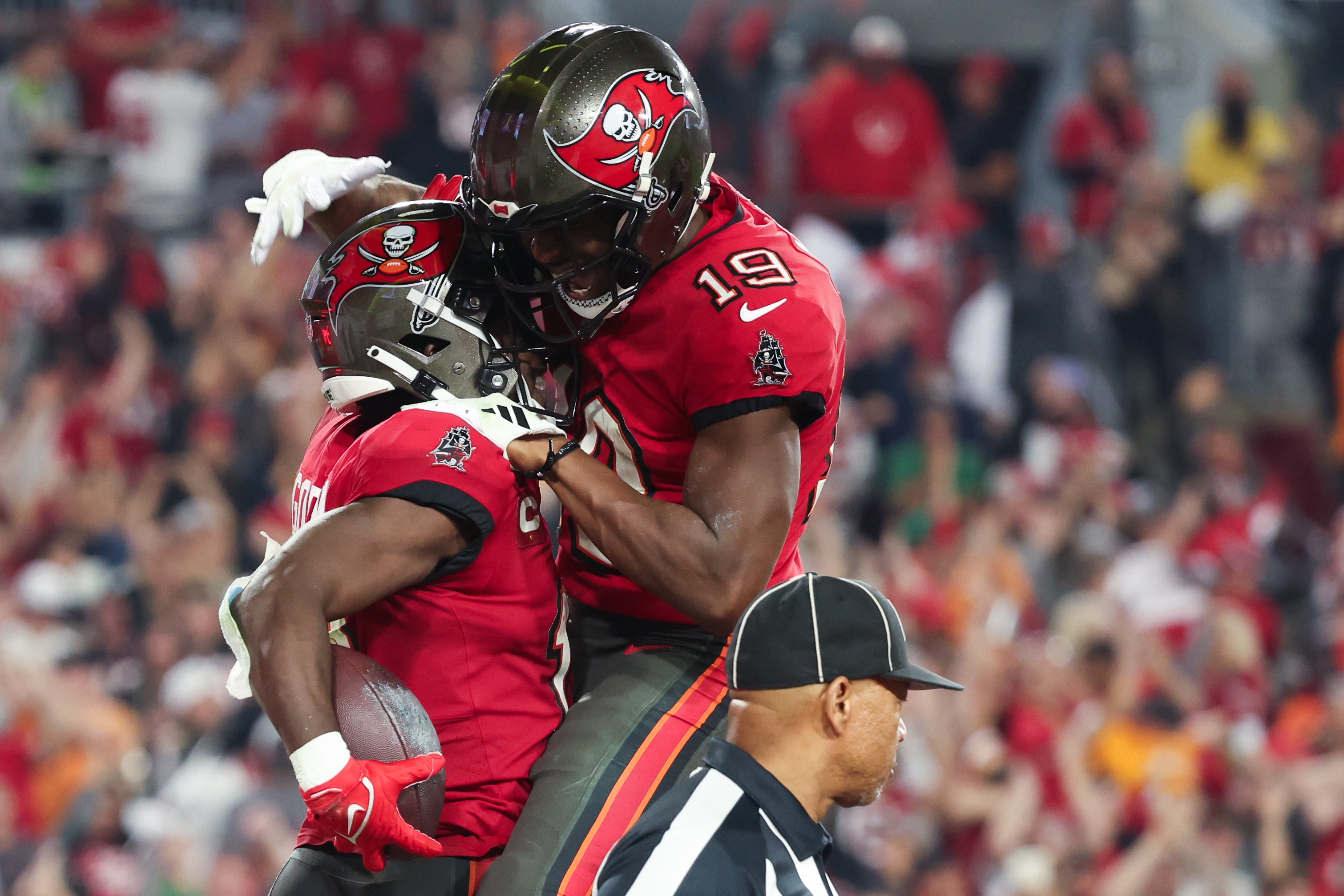 Jan 15, 2024; Tampa, Florida, USA; Tampa Bay Buccaneers wide receiver Chris Godwin (14) celebrates his touchdown with wide receiver David Moore (19) against the Philadelphia Eagles during the second half of a 2024 NFC wild card game at Raymond James Stadium. Mandatory Credit: Kim Klement Neitzel-USA TODAY Sports