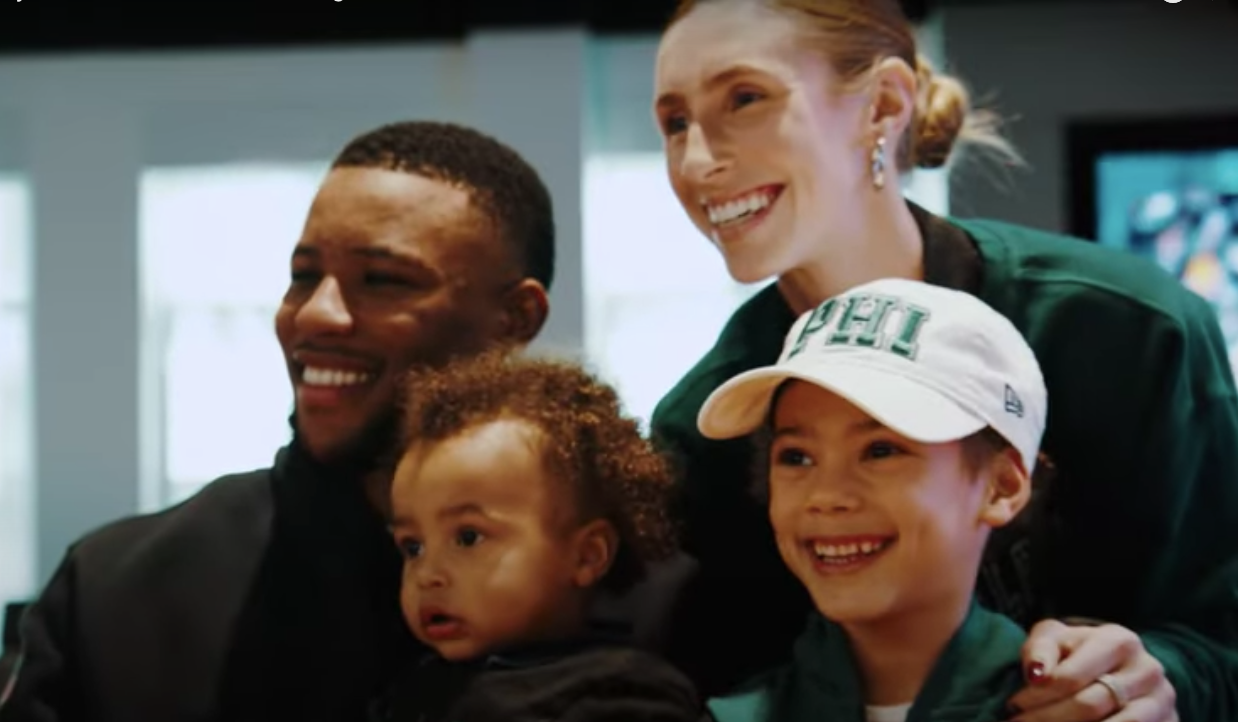 Saquon Barkley poses with his wife and two kids after signing his new contract with the Philadelphia Eagles.