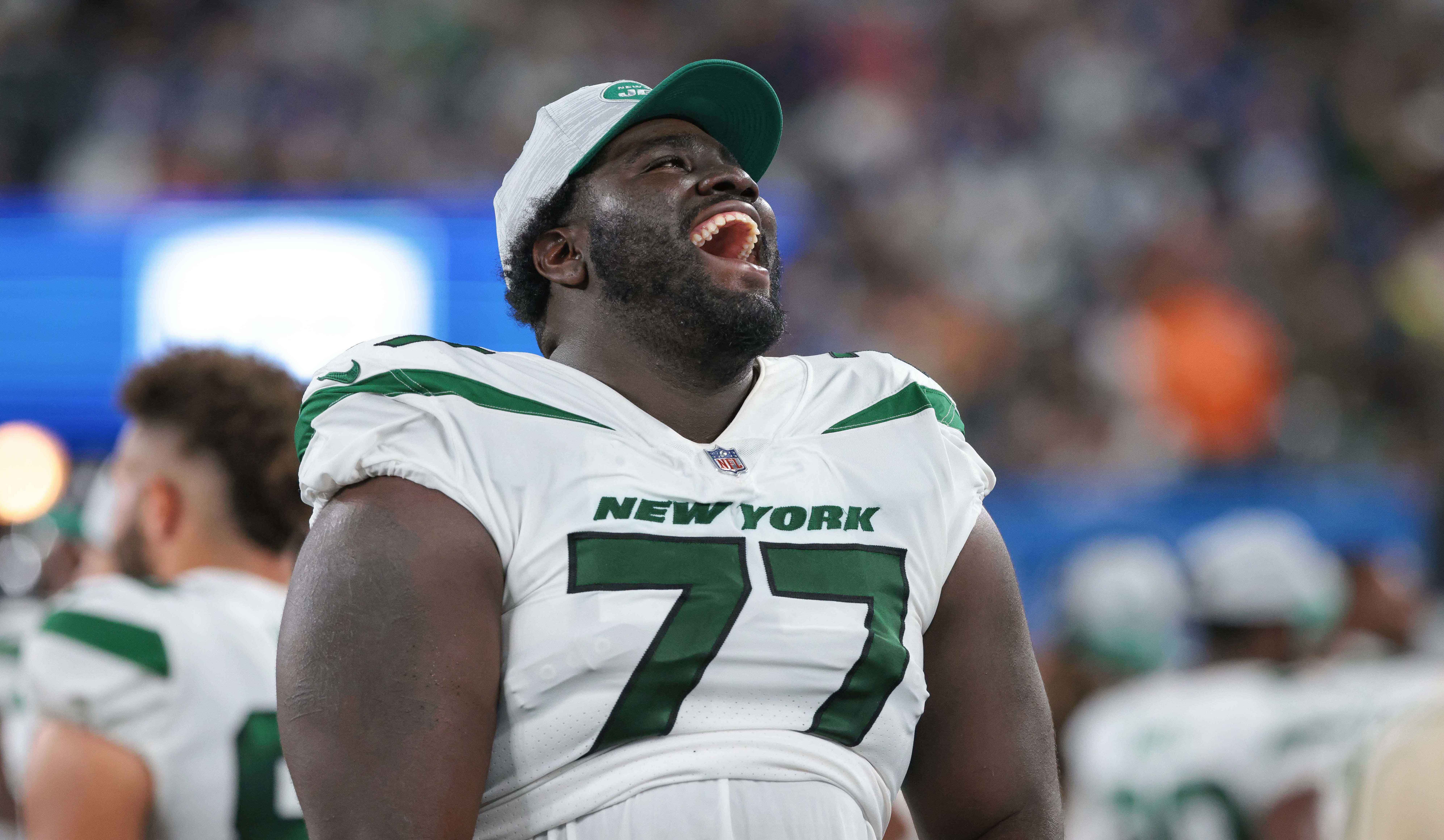 New York Jets offensive tackle Mekhi Becton (77) laughs during the second half against the New York Giants at MetLife Stadium. Vincent Carchietta-USA TODAY Sports