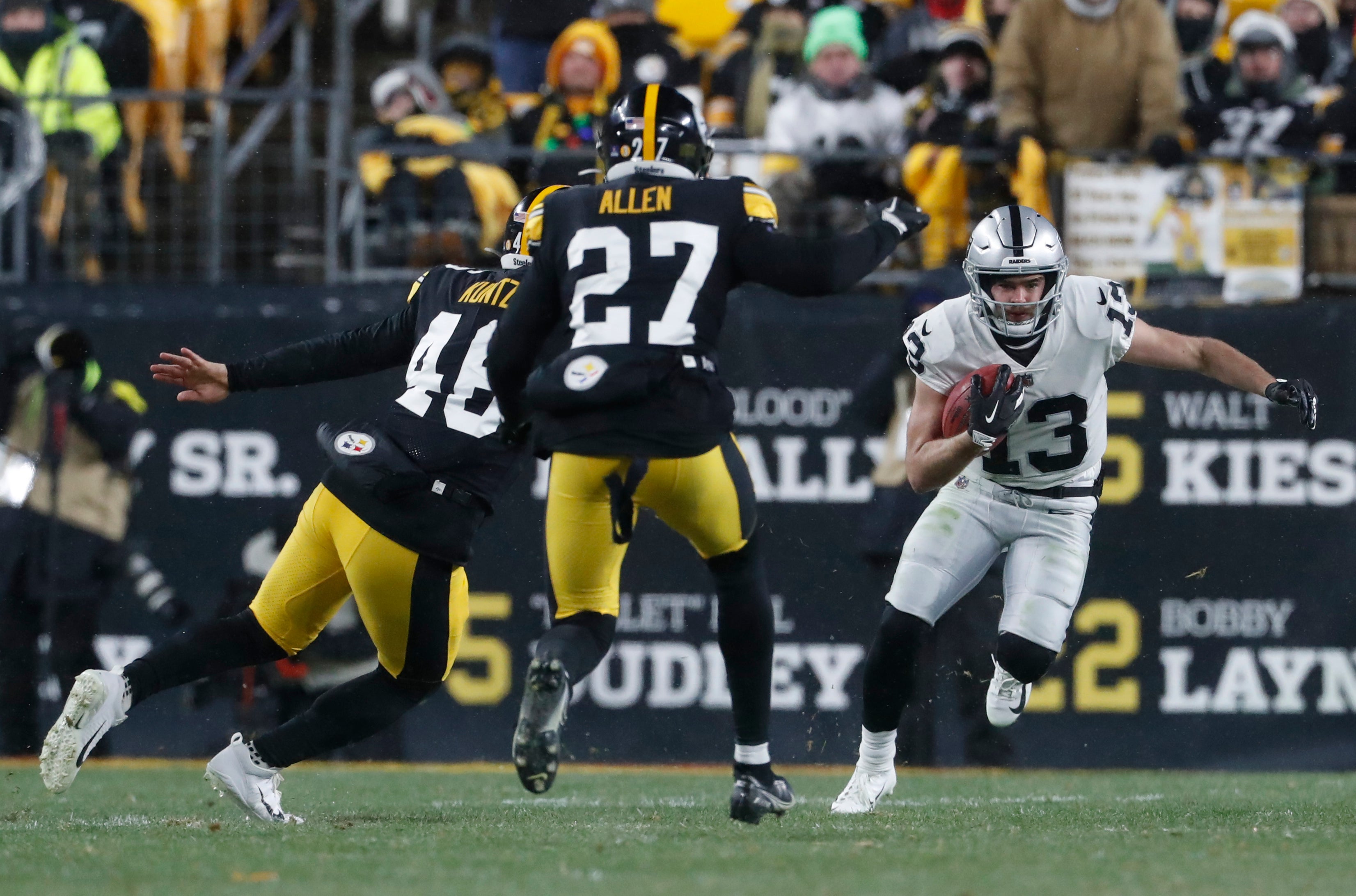 Dec 24, 2022; Pittsburgh, Pennsylvania, USA; Las Vegas Raiders wide receiver Hunter Renfrow (13) returns a punt against Pittsburgh Steelers long snapper Christian Kuntz (46) and linebacker Marcus Allen (27) during the third quarter at Acrisure Stadium. The Steelers won 13-10. Mandatory Credit: Charles LeClaire-USA TODAY Sports