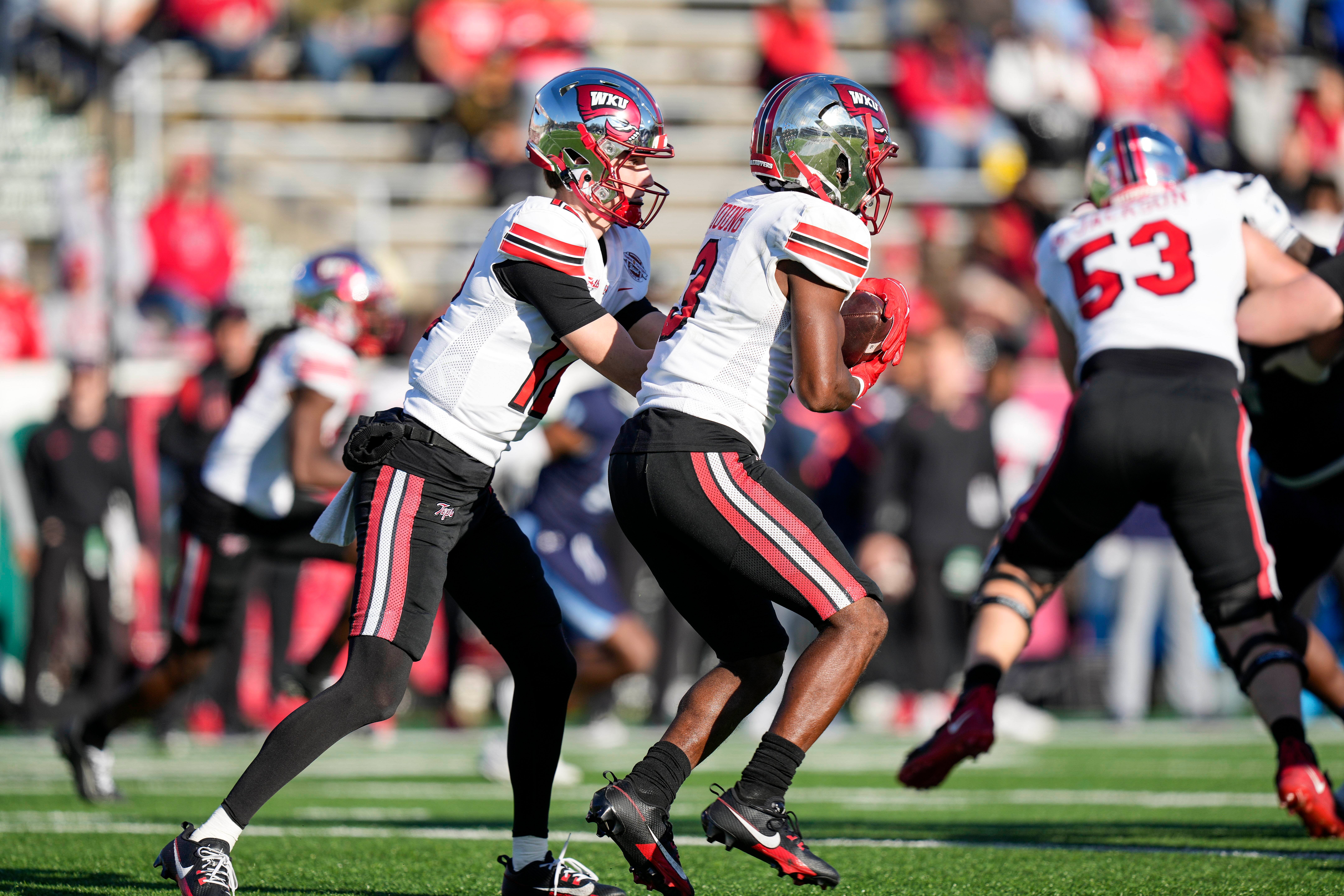 Dec 18, 2023; Charlotte, NC, USA; Western Kentucky Hilltoppers wide receiver Malachi Corley (11) hands off to running back Elijah Young (3) against the Old Dominion Monarchs during the first quarter at Charlotte 49ers' Jerry Richardson Stadium. Mandatory Credit: Jim Dedmon-USA TODAY Sports
