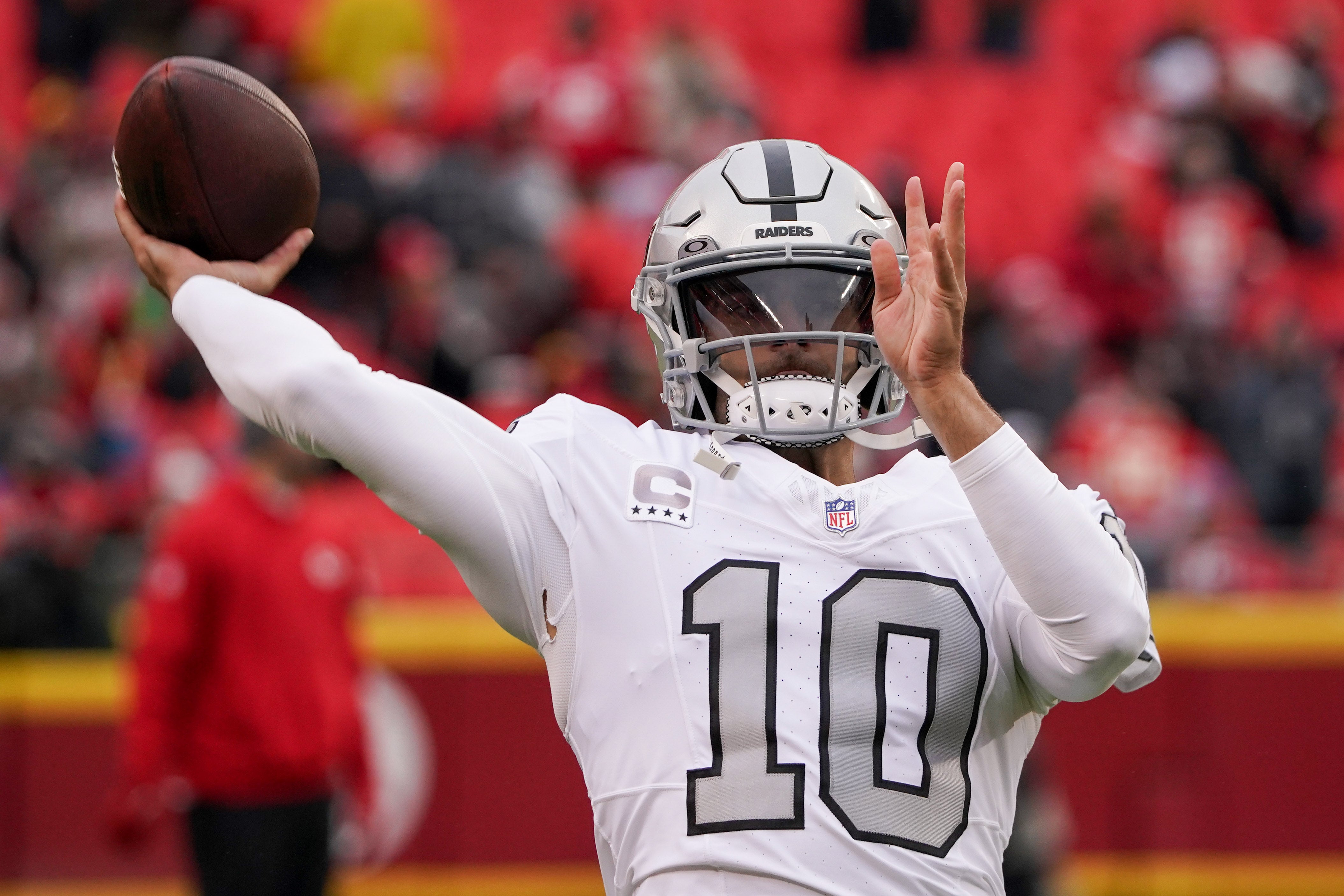 Dec 25, 2023; Kansas City, Missouri, USA; Las Vegas Raiders quarterback Jimmy Garoppolo (10) warms up against the Kansas City Chiefs prior to a game at GEHA Field at Arrowhead Stadium. Mandatory Credit: Denny Medley-USA TODAY Sports