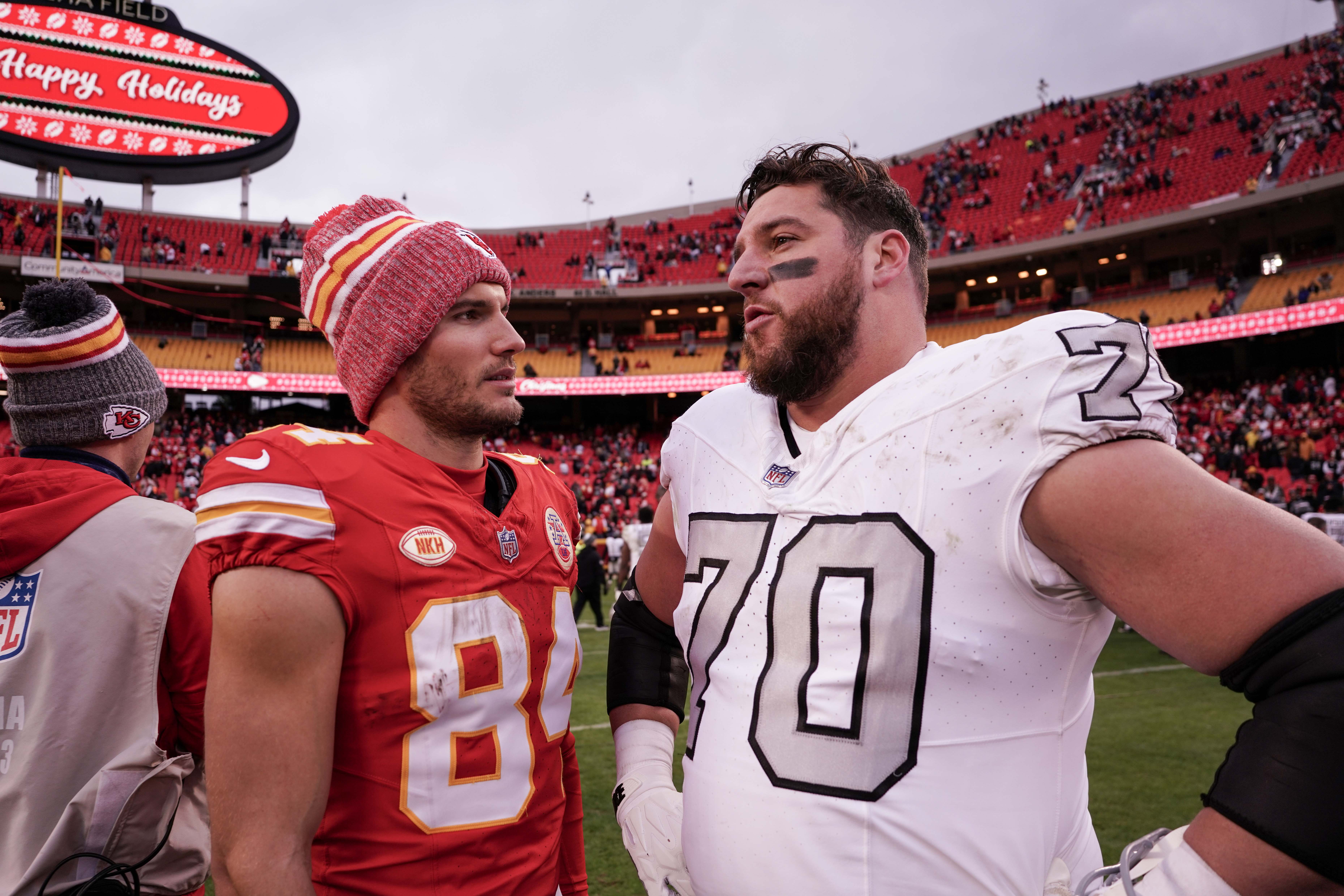 Dec 25, 2023; Kansas City, Missouri, USA; Kansas City Chiefs wide receiver Justin Watson (84) talks with Las Vegas Raiders guard Greg Van Roten (70) after the game at GEHA Field at Arrowhead Stadium.