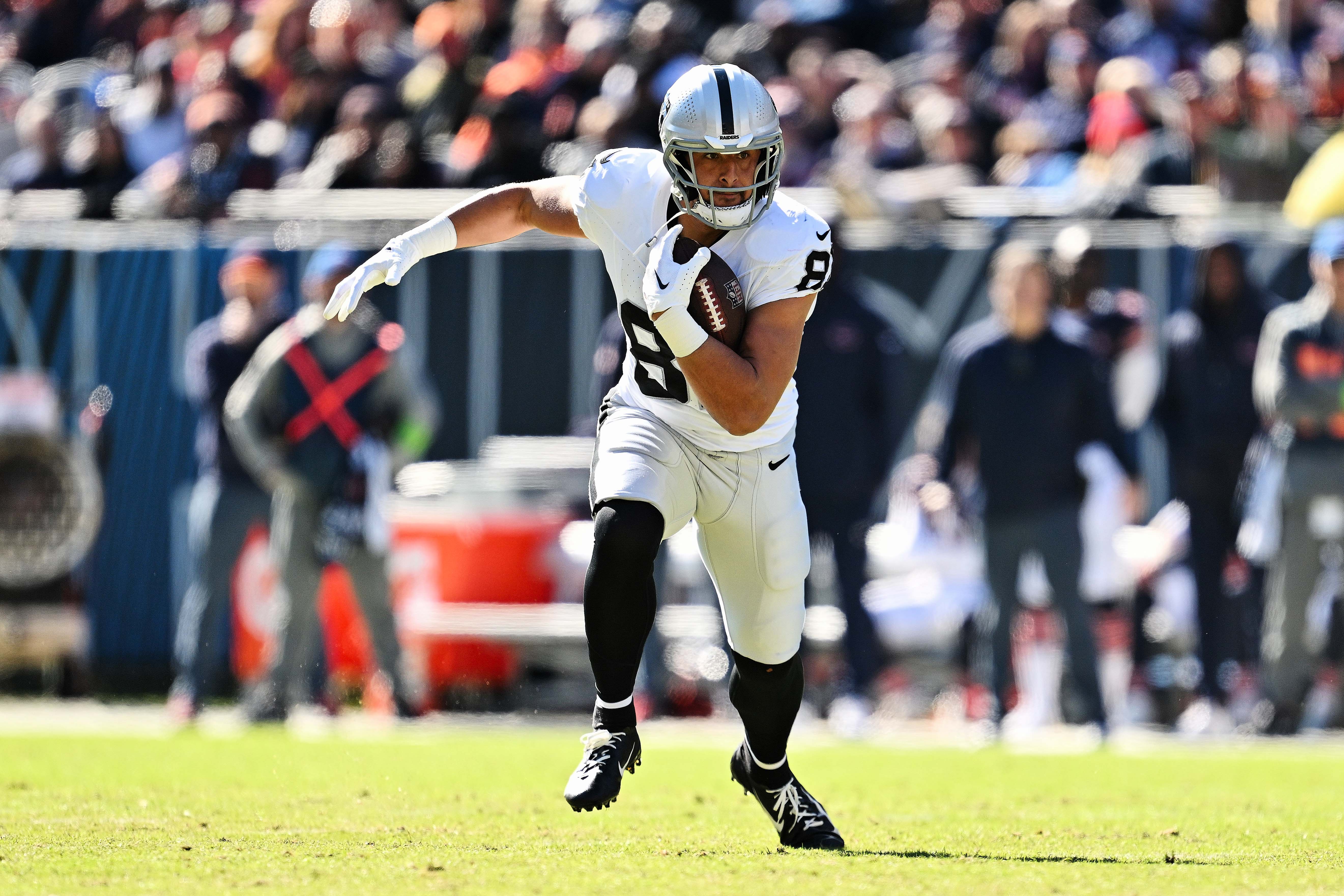 Oct 22, 2023; Chicago, Illinois, USA; Las Vegas Raiders tight end Austin Hooper (81) runs with the ball against the Chicago Bears at Soldier Field