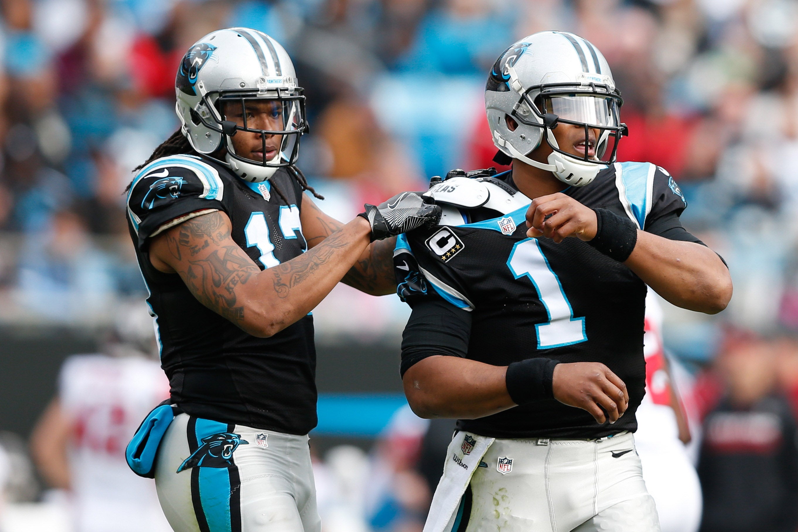 Dec 24, 2016; Charlotte, NC, USA; Carolina Panthers wide receiver Kelvin Benjamin (13) helps quarterback Cam Newton (1) fix his jersey in the first quarter against the Atlanta Falcons at Bank of America Stadium. Mandatory Credit: Jeremy Brevard-USA TODAY Sports