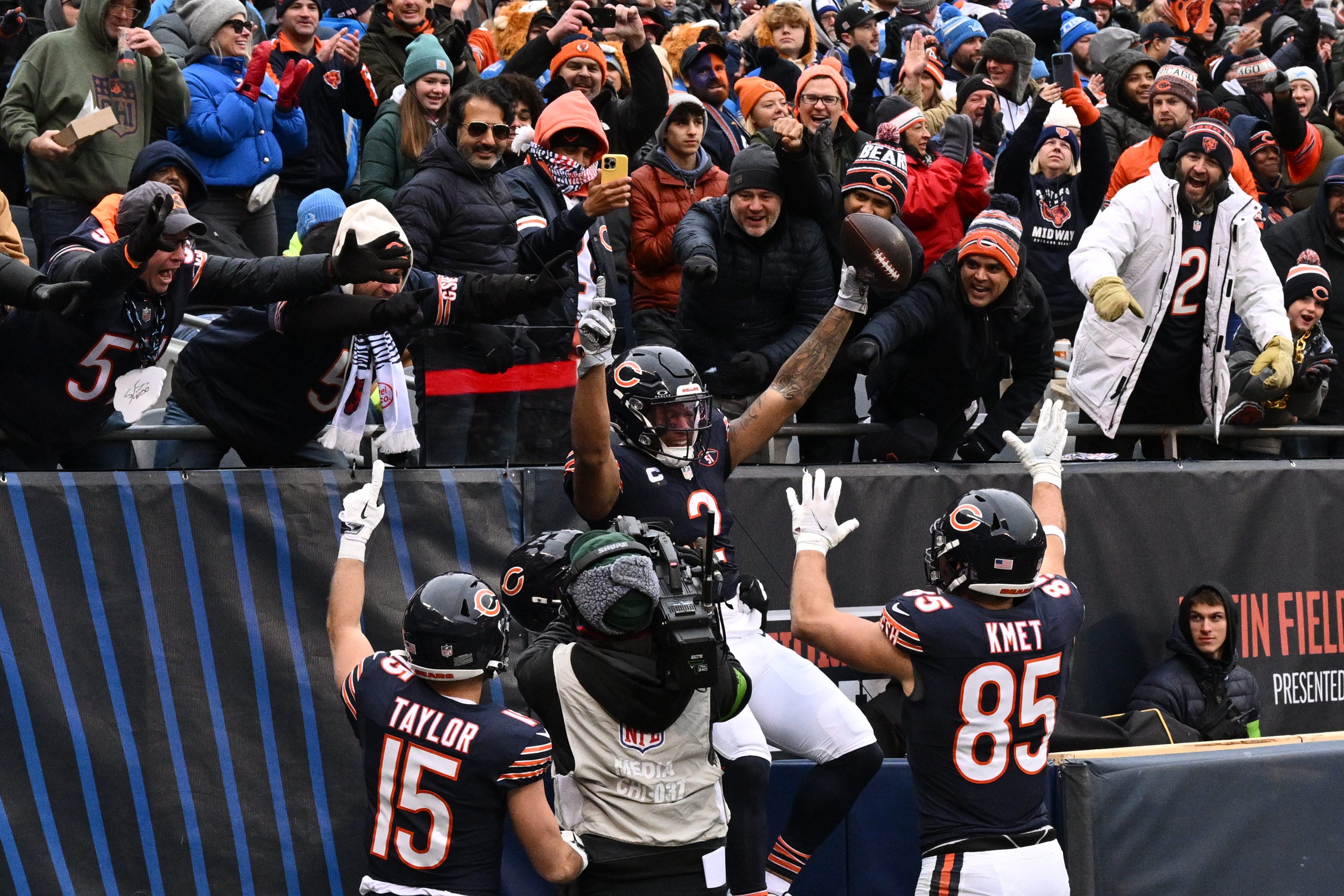 Dec 10, 2023; Chicago, Illinois, USA; Chicago Bears wide receiver DJ Moore (2) celebrates with teammates and fans after scoring a touchdown on a 16-yard run in the first half against the Detroit Lions at Soldier Field.