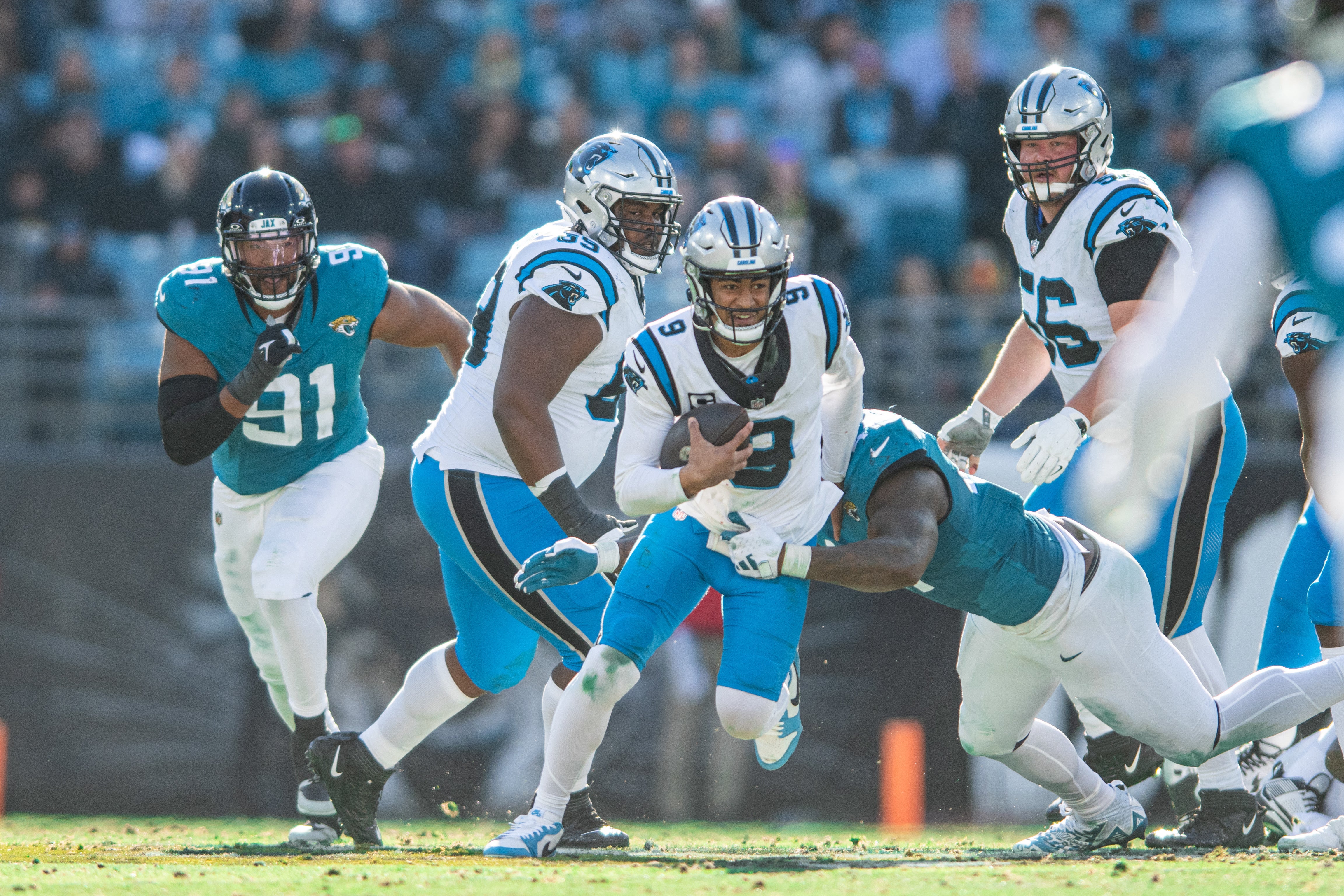 Dec 31, 2023; Jacksonville, Florida, USA; Carolina Panthers quarterback Bryce Young (9) runs the ball against Jacksonville Jaguars linebacker Travon Walker (44) in the third quarter at EverBank Stadium. Mandatory Credit: Jeremy Reper-USA TODAY Sports