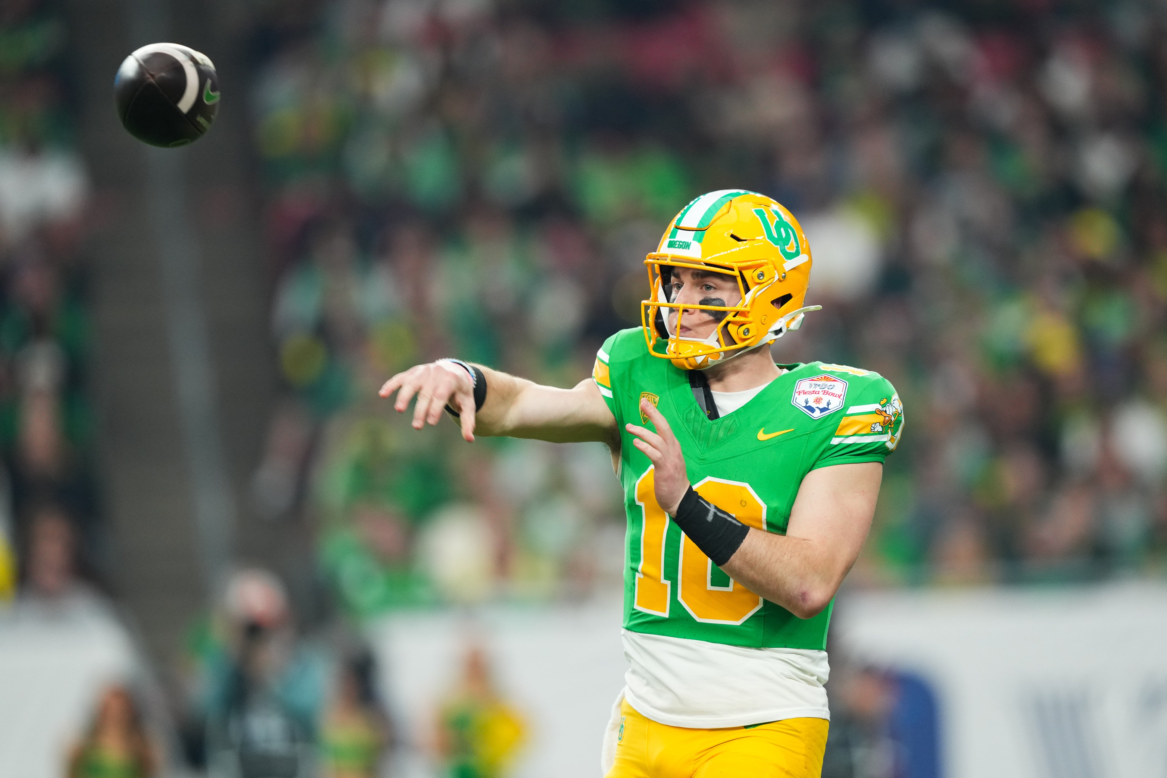 Jan 1, 2024; Glendale, AZ, USA; Oregon Ducks quarterback Bo Nix (10) throws against the Liberty Flames during the second half in the 2024 Fiesta Bowl at State Farm Stadium.