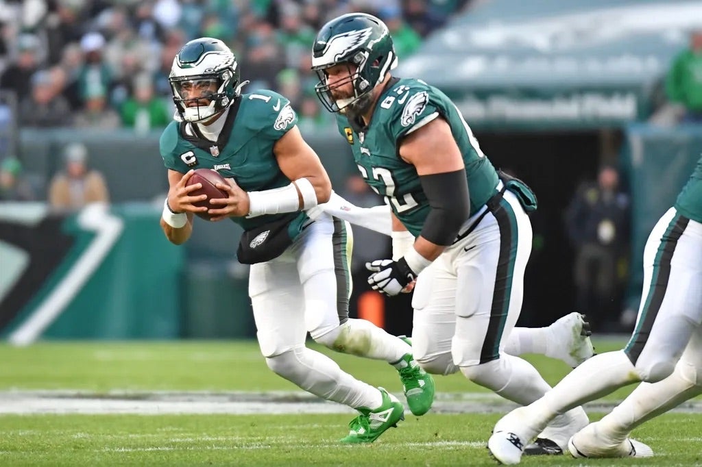 Philadelphia Eagles quarterback Jalen Hurts (1) runs with ball as center Jason Kelce (62) looks to block against the Arizona Cardinals at Lincoln Financial Field.