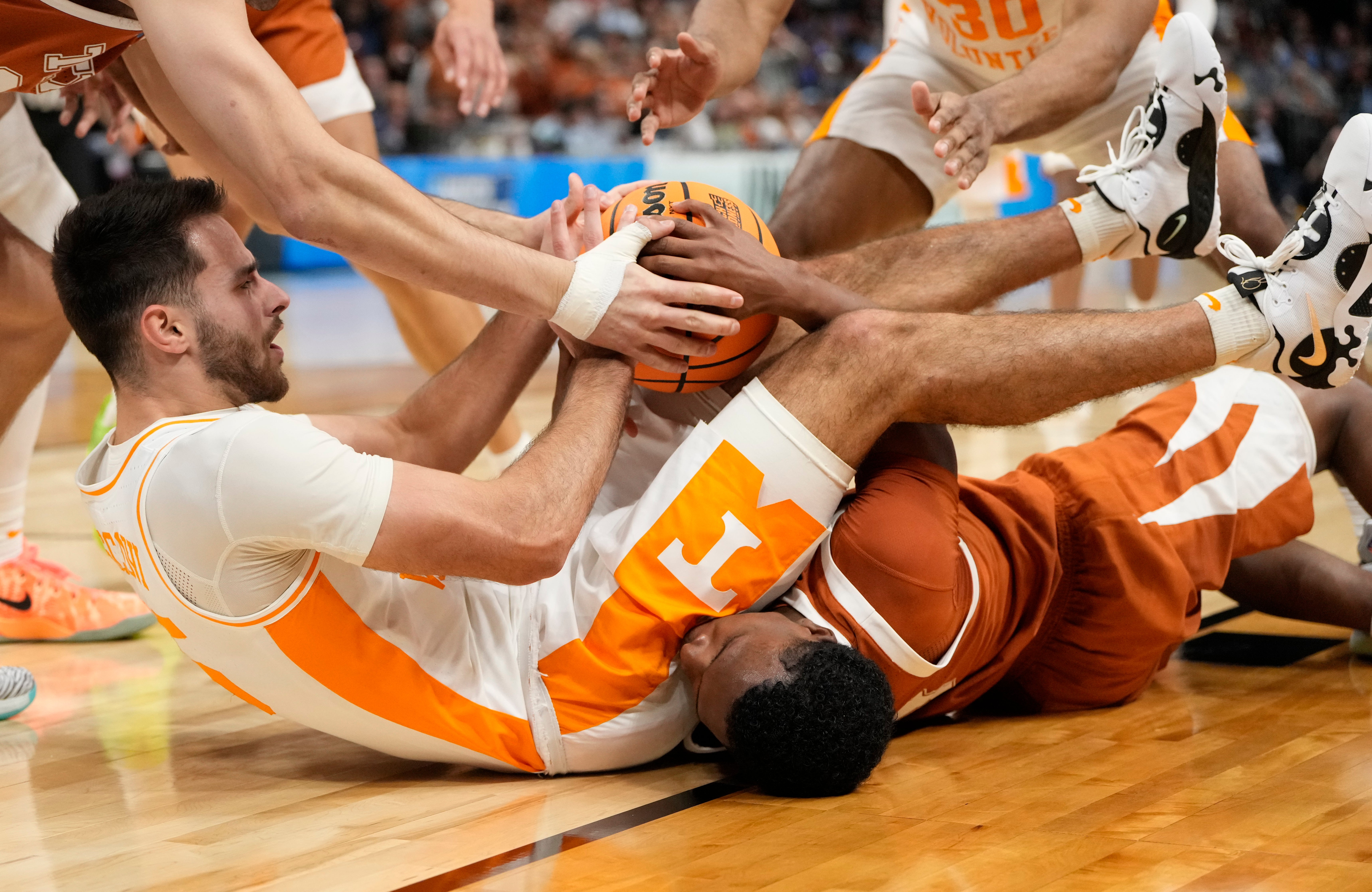 March 23, 2024, Charlotte, NC, USA; Tennessee Volunteers guard Santiago Vescovi (25) battles for the ball on the floor with Texas Longhorns guard Max Abmas (bottom) in the second round of the 2024 NCAA Tournament at the Spectrum Center.