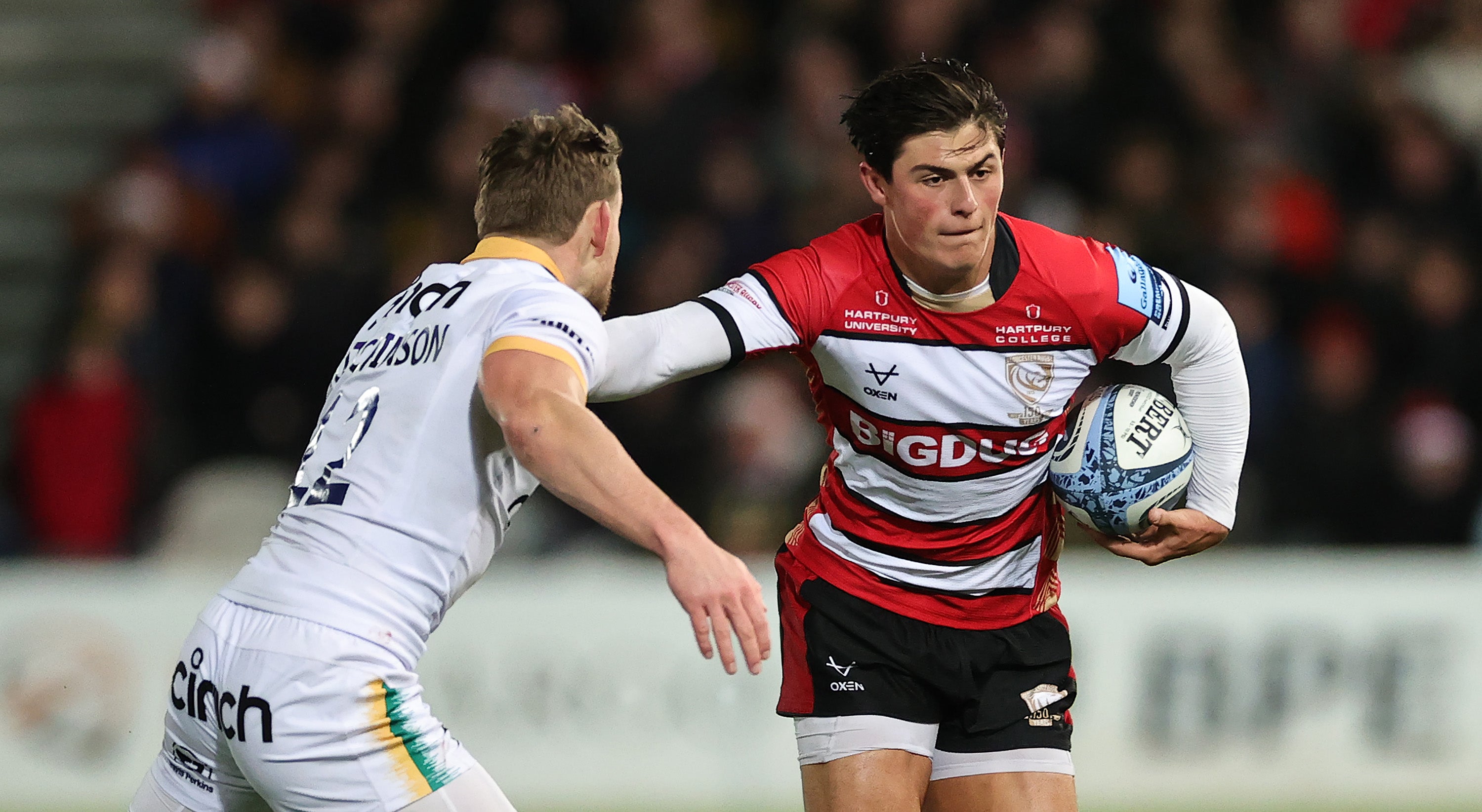 GLOUCESTER, ENGLAND - DECEMBER 23: Louis Rees-Zammit of Gloucester is tackled by Rory Hutchinson during the Gallagher Premiership Rugby match between Gloucester Rugby and Northampton Saints at Kingsholm Stadium on December 23, 2023 in Gloucester, England.