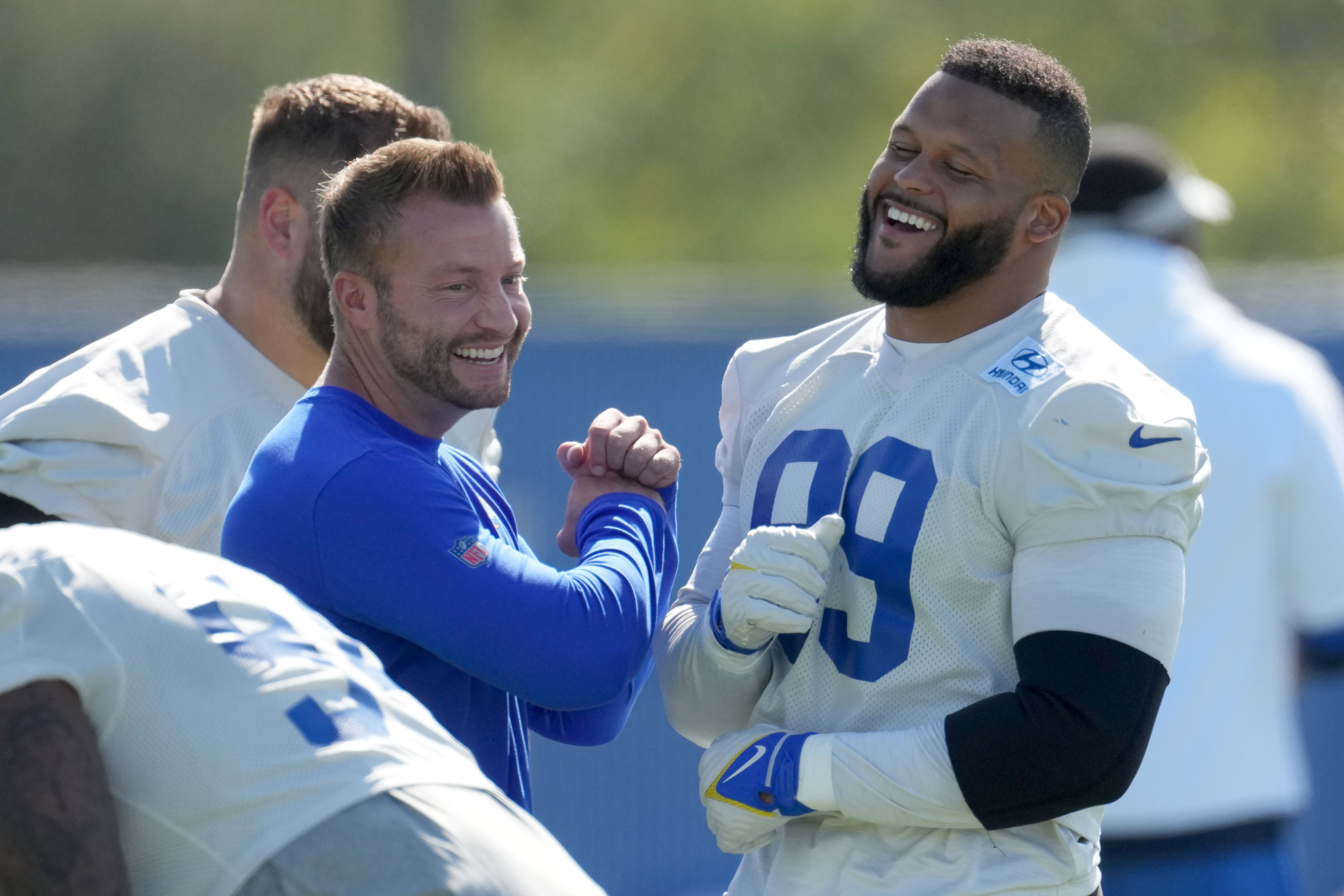 Jun 7, 2022; Thousand Oaks California, USA; Los Angeles Rams defensive end Aaron Donald (99) and coach Sean McVay react during minicamp at Cal Lutheran University. Mandatory Credit: Kirby Lee-USA TODAY Sports