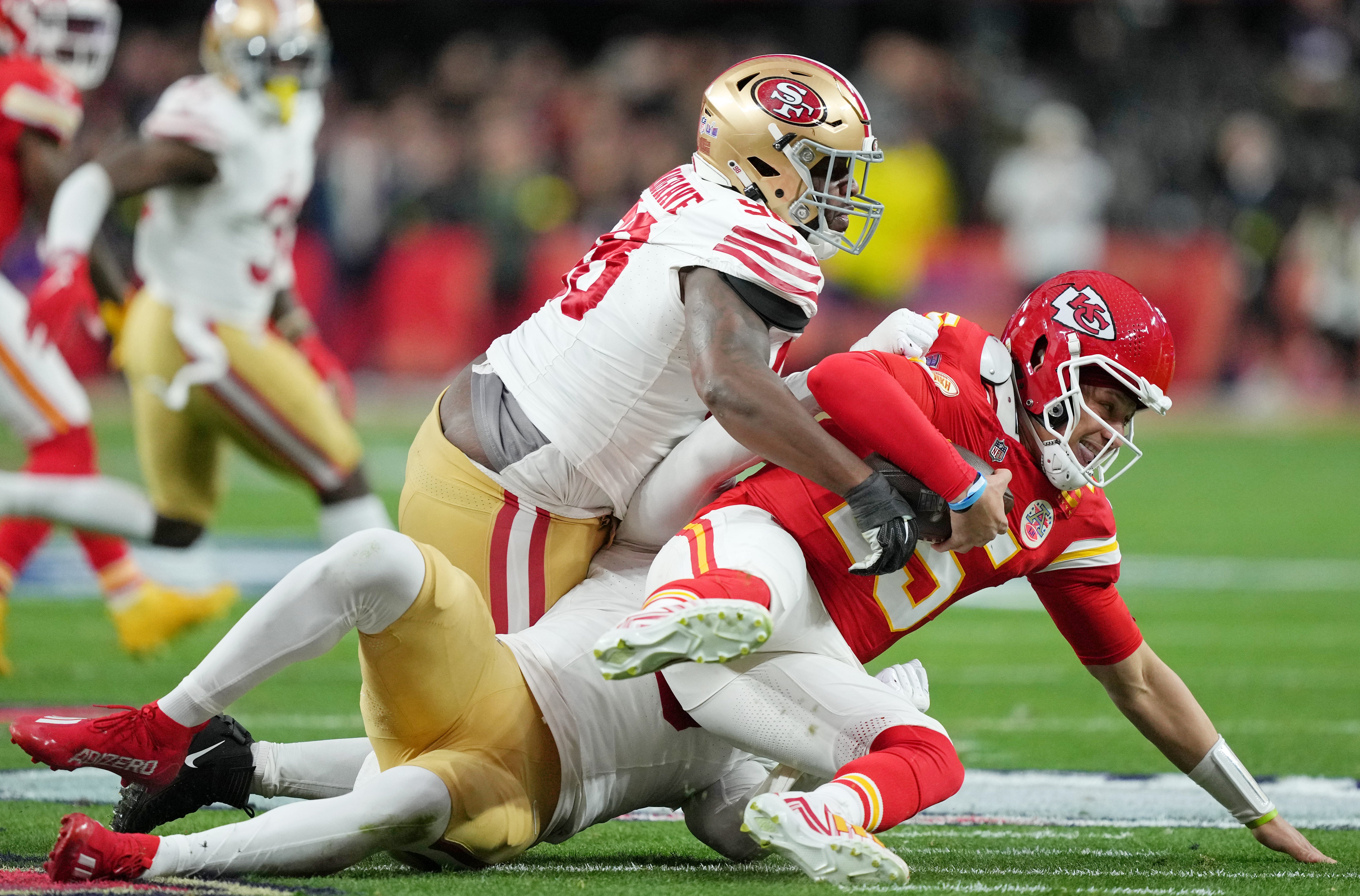 Feb 11, 2024; Paradise, Nevada, USA; San Francisco 49ers defensive tackle Javon Hargrave (98) and linebacker Randy Gregory (5) sack Kansas City Chiefs quarterback Patrick Mahomes (15) during the first quarter of Super Bowl LVIII at Allegiant Stadium.