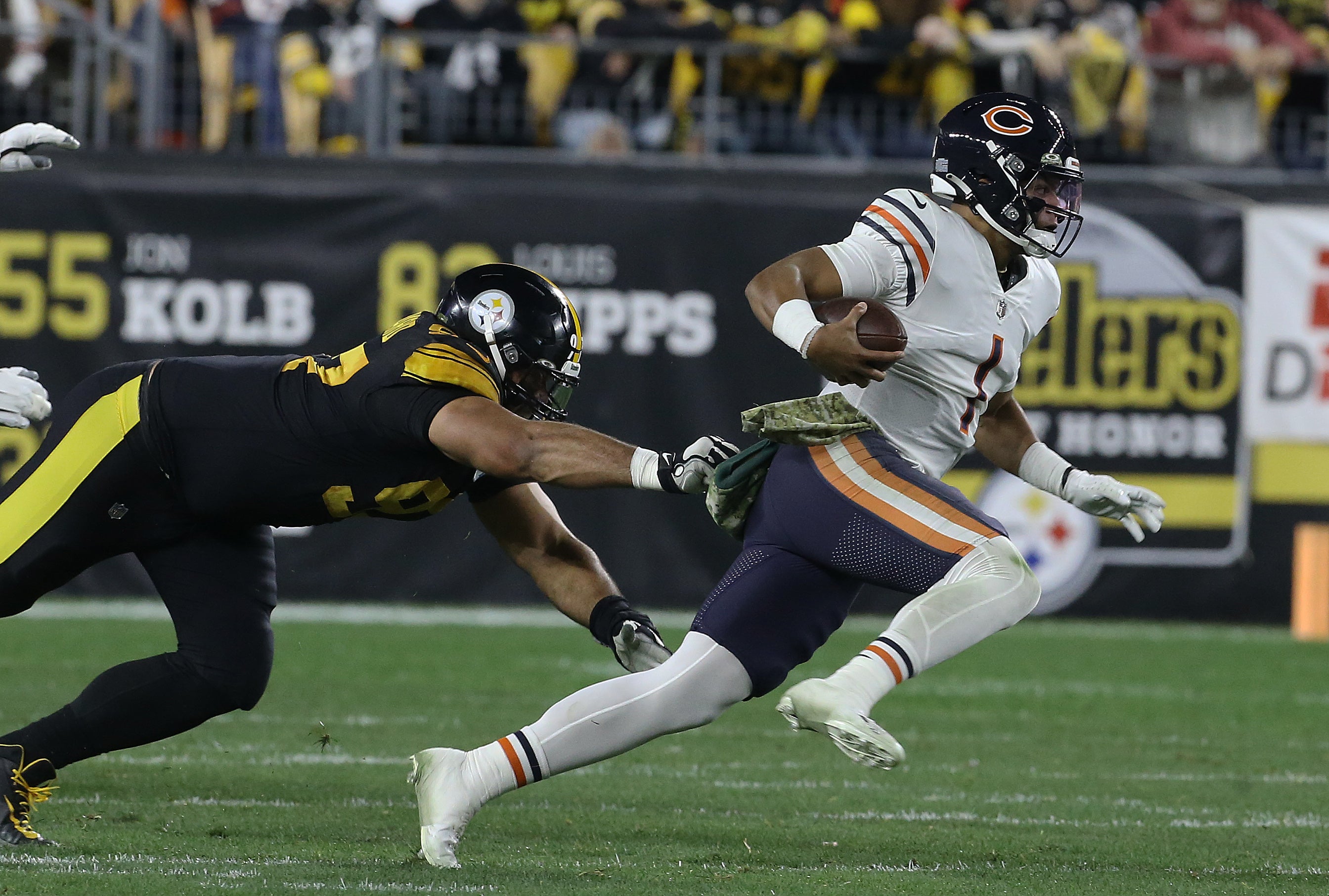 Nov 8, 2021; Pittsburgh, Pennsylvania, USA; Chicago Bears quarterback Justin Fields (1) and Pittsburgh Steelers defensive end Cameron Heyward (97) during the first quarter at Heinz Field. Mandatory Credit: Charles LeClaire-USA TODAY Sports  