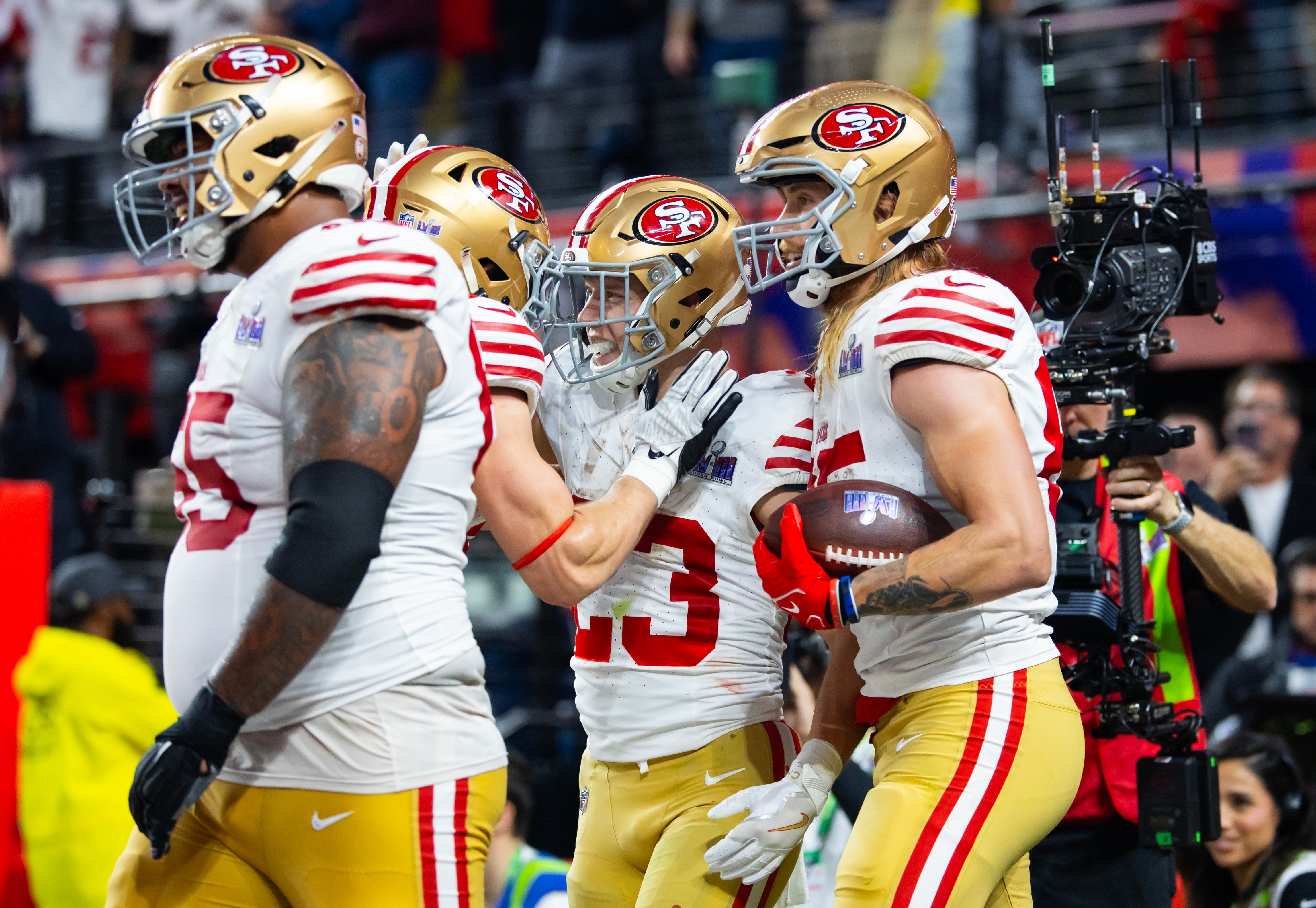 Feb 11, 2024; Paradise, Nevada, USA; San Francisco 49ers running back Christian McCaffrey (23) celebrates with tight end George Kittle (85) after scoring a touchdown in the first half of Super Bowl LVIII at Allegiant Stadium.