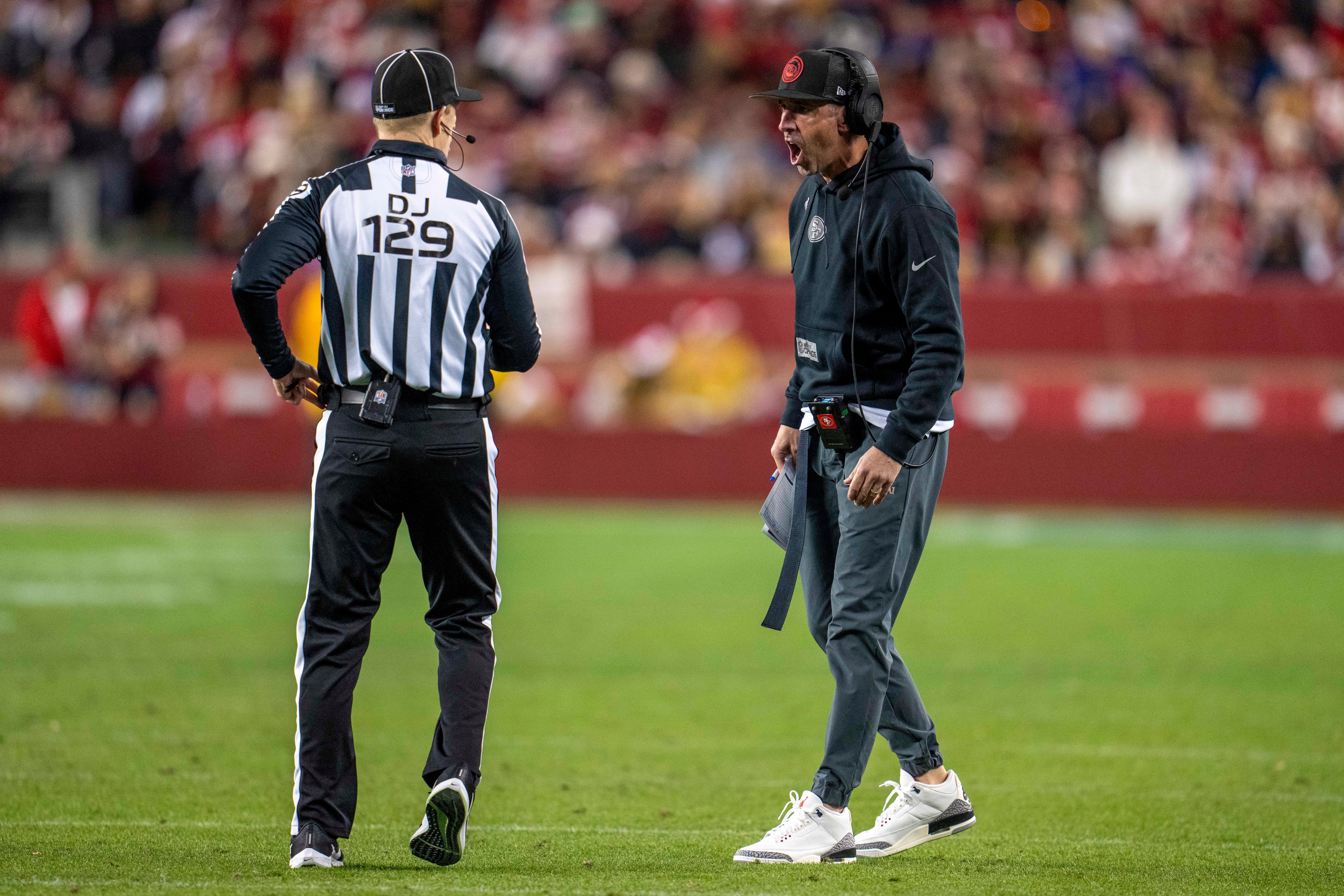 Dec 25, 2023; Santa Clara, California, USA; San Francisco 49ers head coach Kyle Shanahan reacts in front of NFL down judge Dale Keller (129) during the fourth quarter at Levi's Stadium.