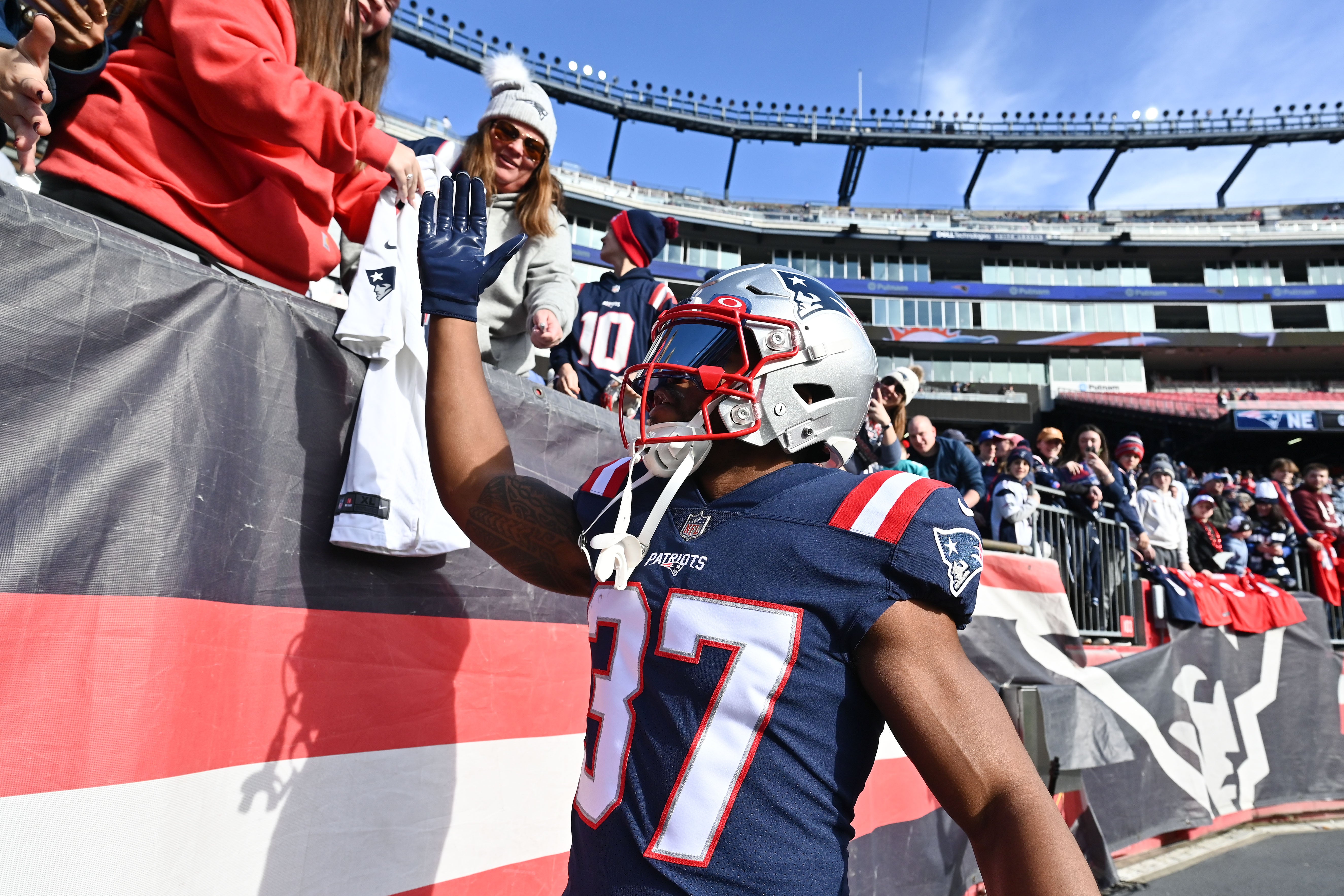 Jan 1, 2023; Foxborough, Massachusetts, USA; New England Patriots running back Damien Harris (37) high-fives fans before a game against the Miami Dolphins at Gillette Stadium.