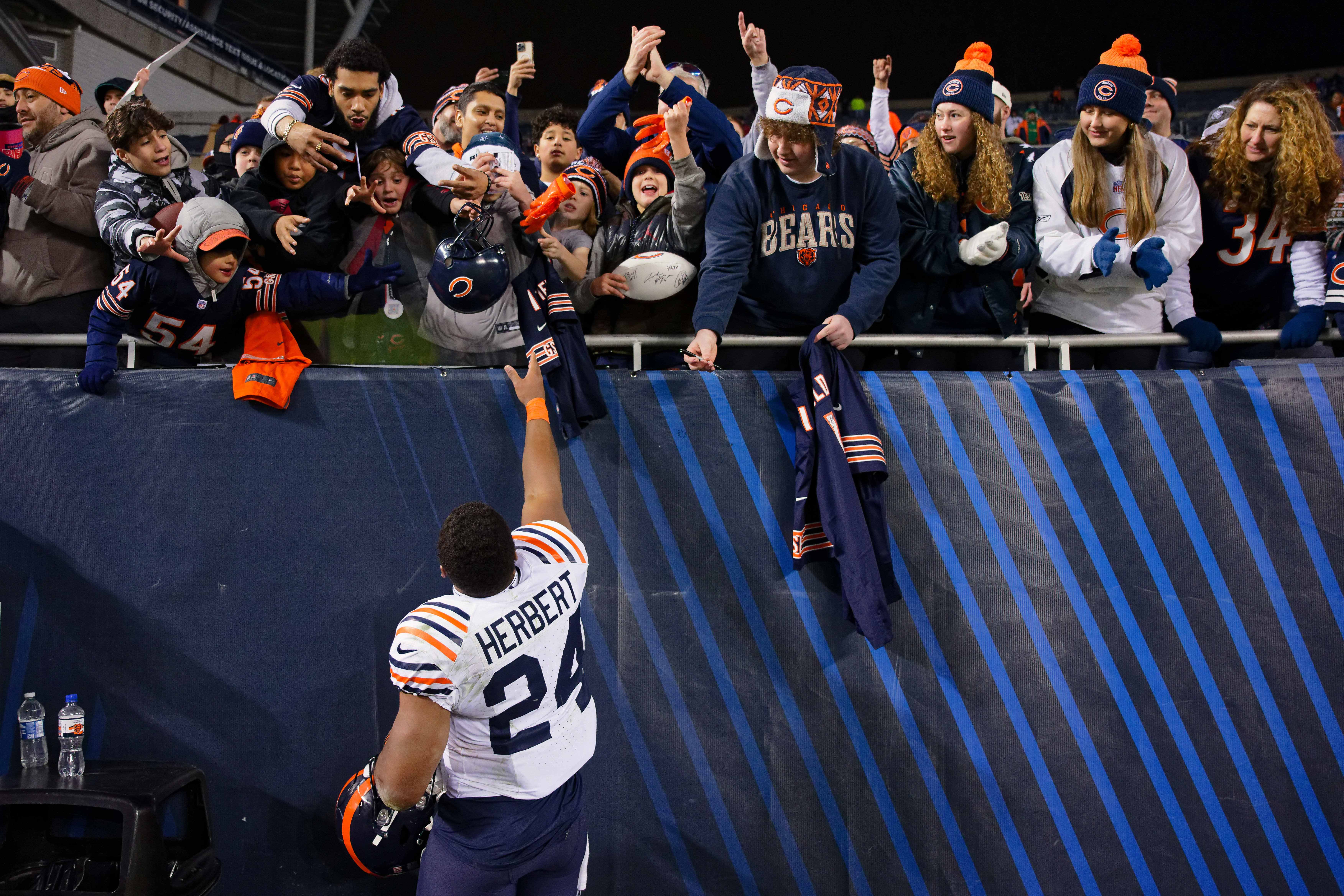Dec 24, 2023; Chicago, Illinois, USA; Chicago Bears running back Khalil Herbert (24) throws his gloves to fans after a gam against the Arizona Cardinals at Soldier Field.