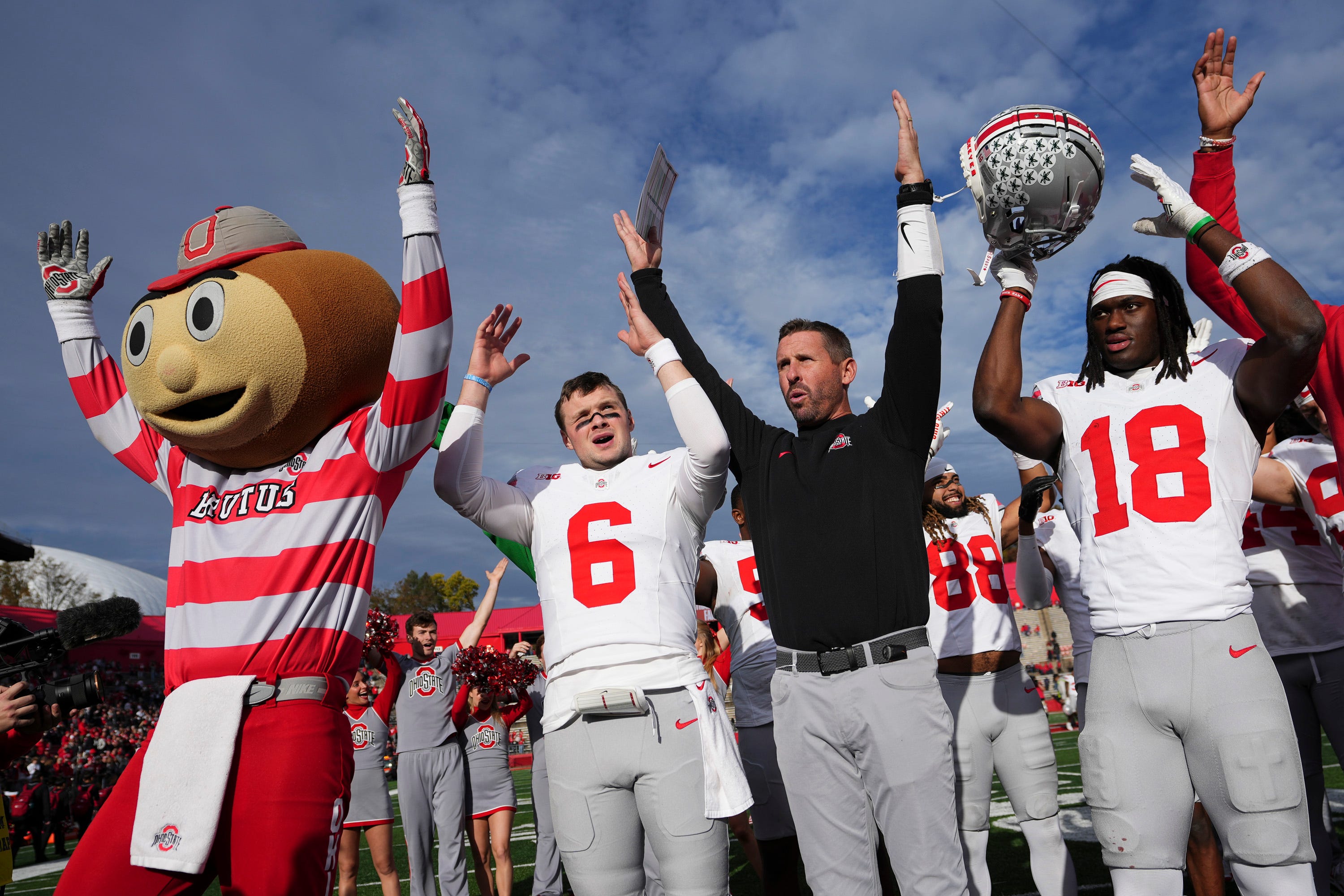 Nov 4, 2023; Piscataway, New Jersey, USA; Ohio State Buckeyes quarterback Kyle McCord (6), offensive coordinator Brian Hartline and wide receiver Marvin Harrison Jr. (18) sing Carmen Ohio following the NCAA football game against the Rutgers Scarlet Knights at SHI Stadium. Ohio State won 35-16.