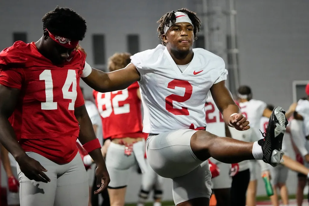 Ohio State Buckeyes safety Caleb Downs (2) stretches with wide receiver Kojo Antwi (14) during the first spring practice at the Woody Hayes Athletic Center