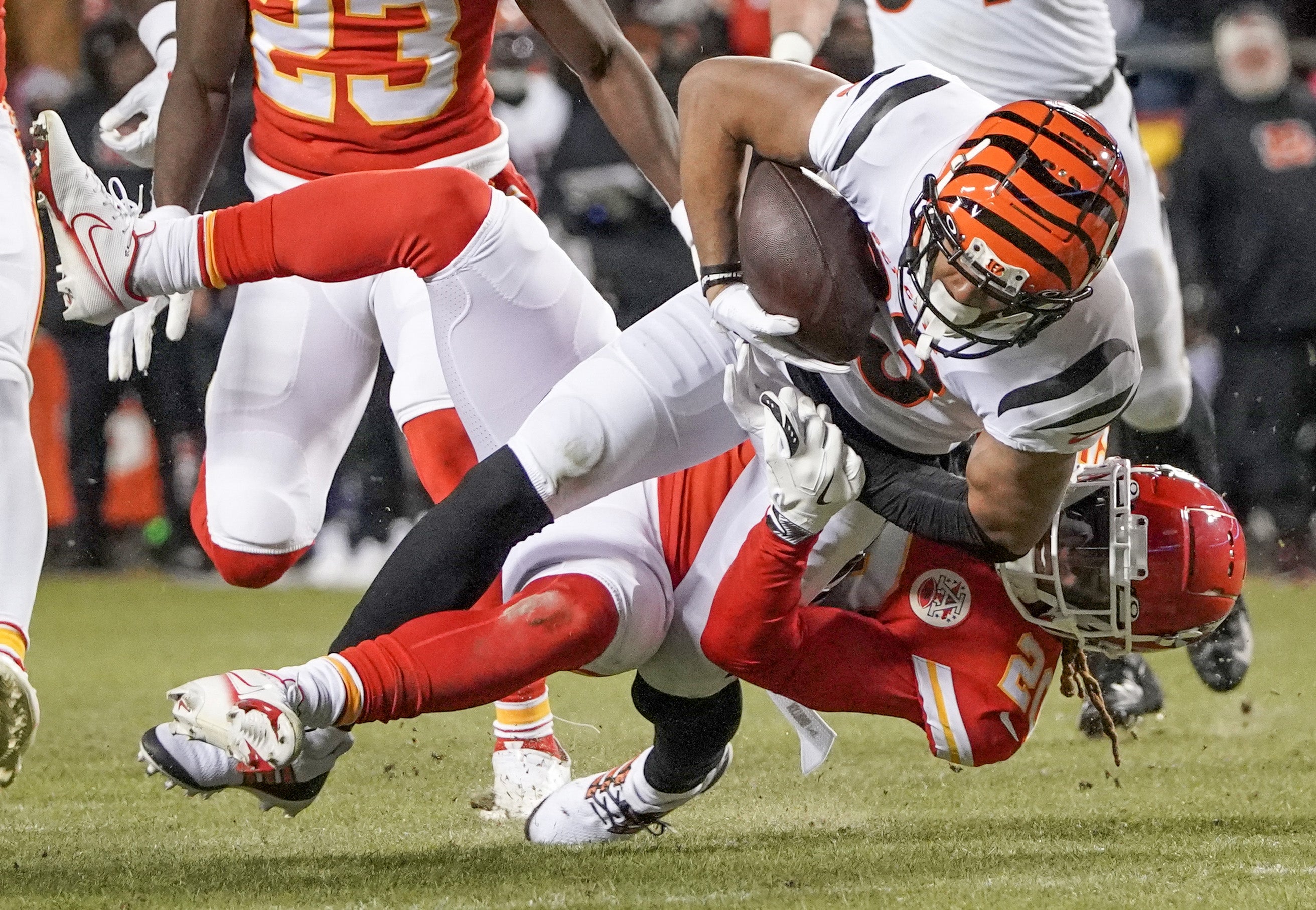 Jan 29, 2023; Kansas City, Missouri, USA; Cincinnati Bengals wide receiver Tyler Boyd (83) runs the ball as Kansas City Chiefs safety Justin Reid (20) makes the tackle during the AFC Championship game at GEHA Field at Arrowhead Stadium.