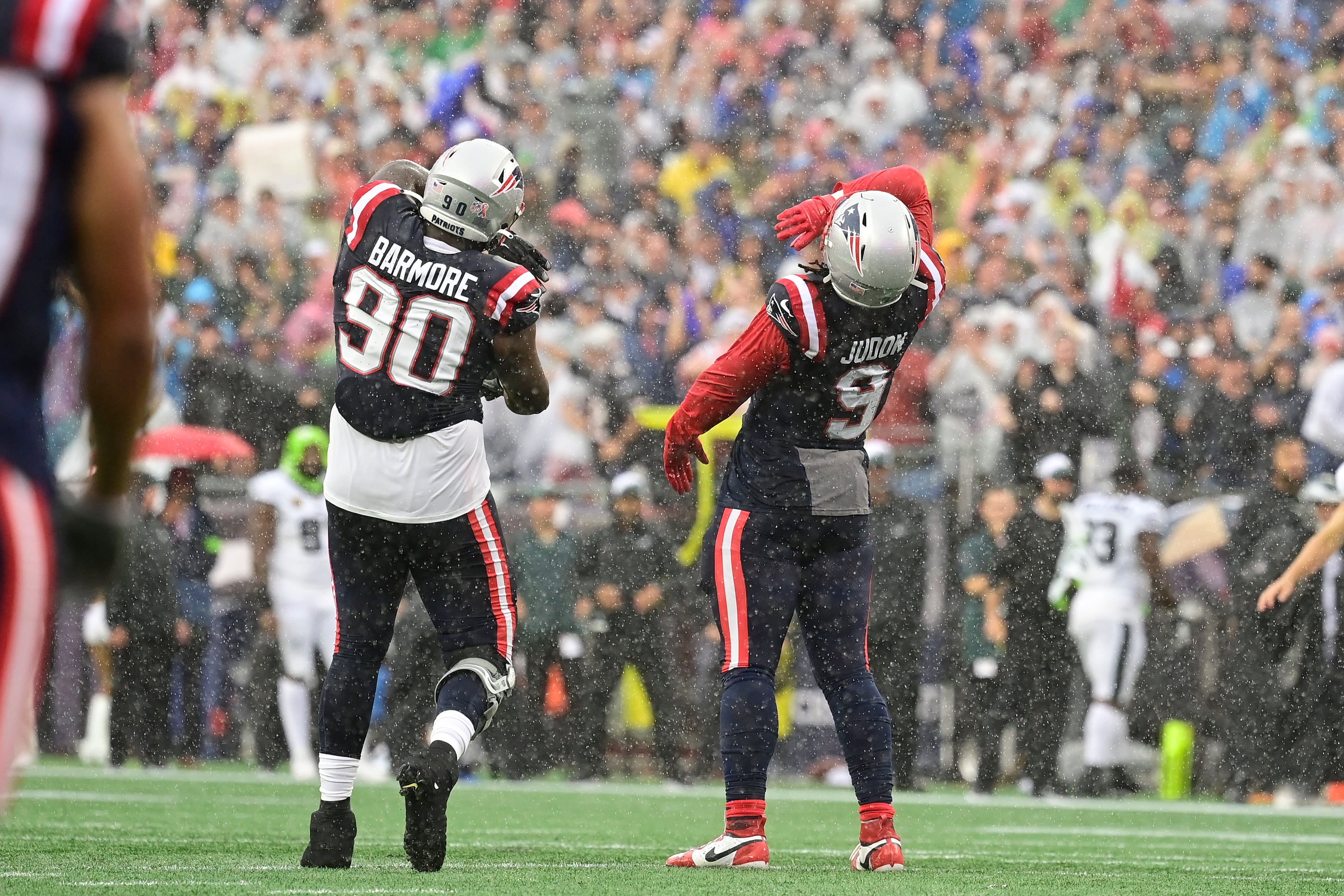 Foxborough, Massachusetts, USA; New England Patriots linebacker Matthew Judon (9) and defensive tackle Christian Barmore (90) celebrate a sack during the first half against the Philadelphia Eagles at Gillette Stadium.