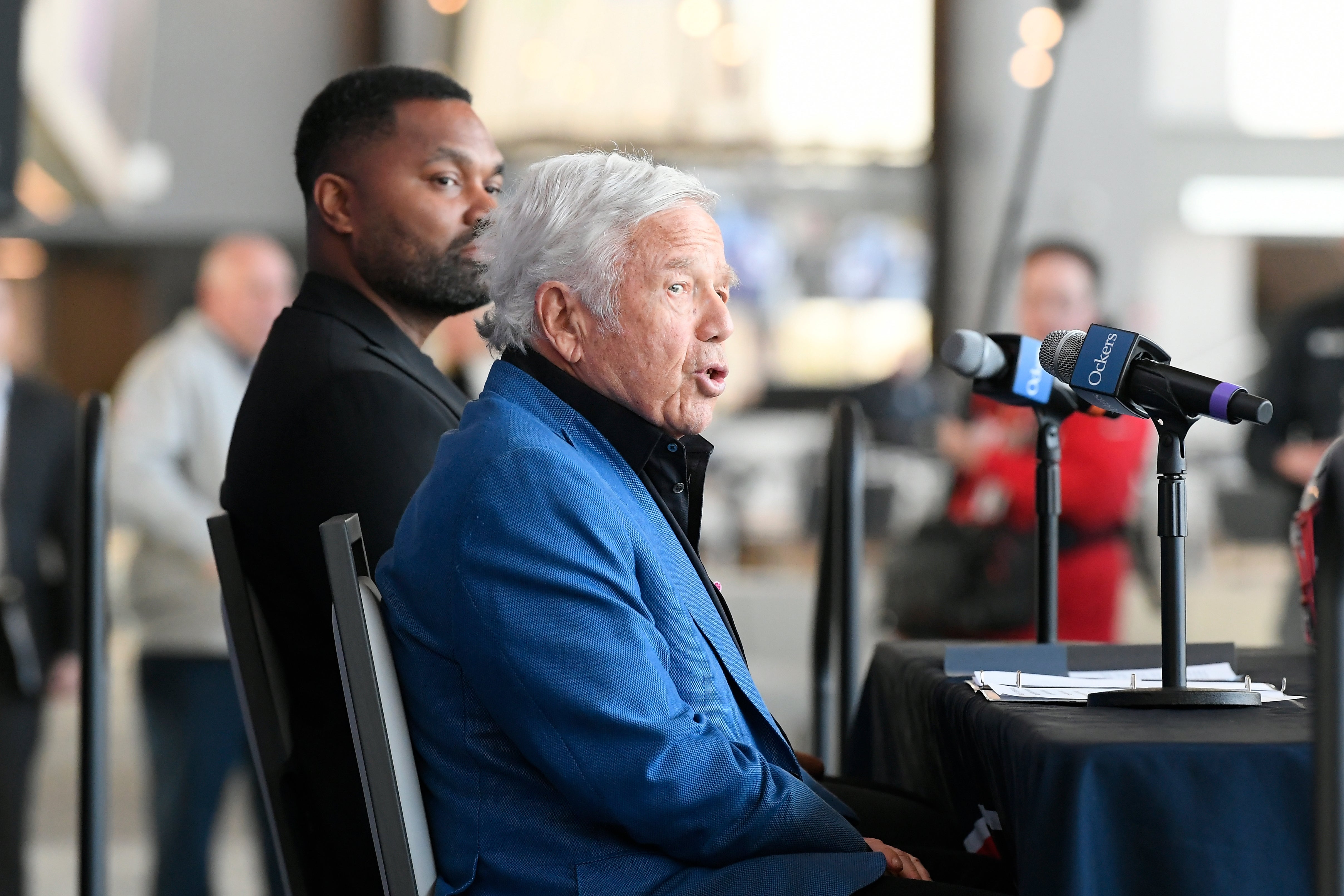 Jan 17, 2024; Foxborough, MA, USA; New England Patriots owner Robert Kraft answers questions from the media about the hiring of head coach Jerod Mayo (background) at a press conference at Gillette Stadium.