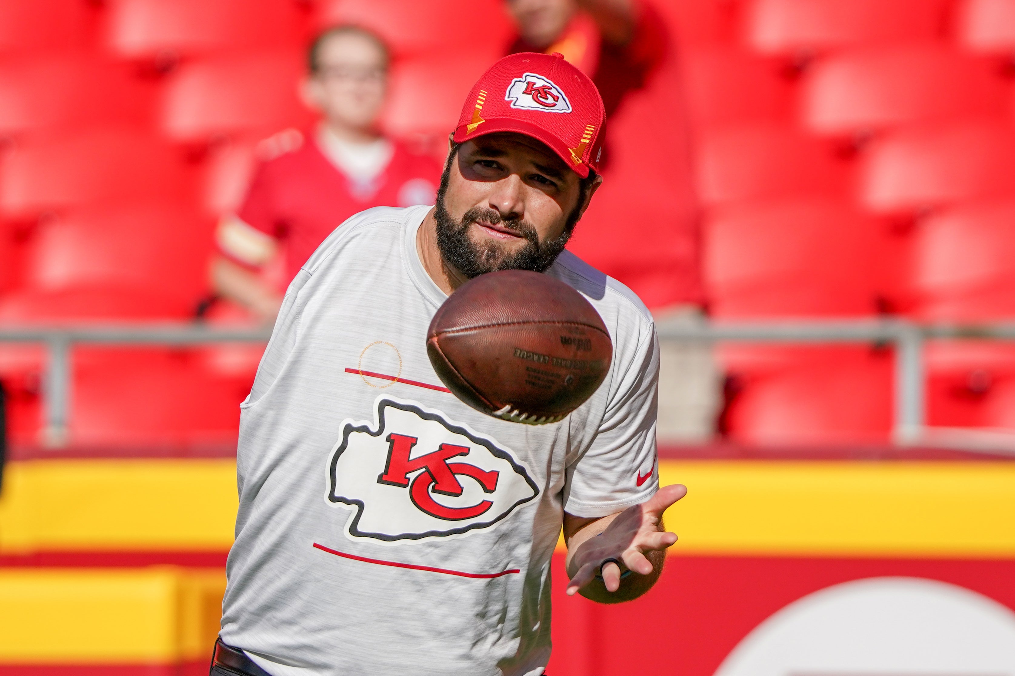 Sep 26, 2021; Kansas City, Missouri, USA; Kansas City Chiefs assistant coach Porter Ellett helps during warmups against the Los Angeles Chargers before the game at GEHA Field at Arrowhead Stadium.
